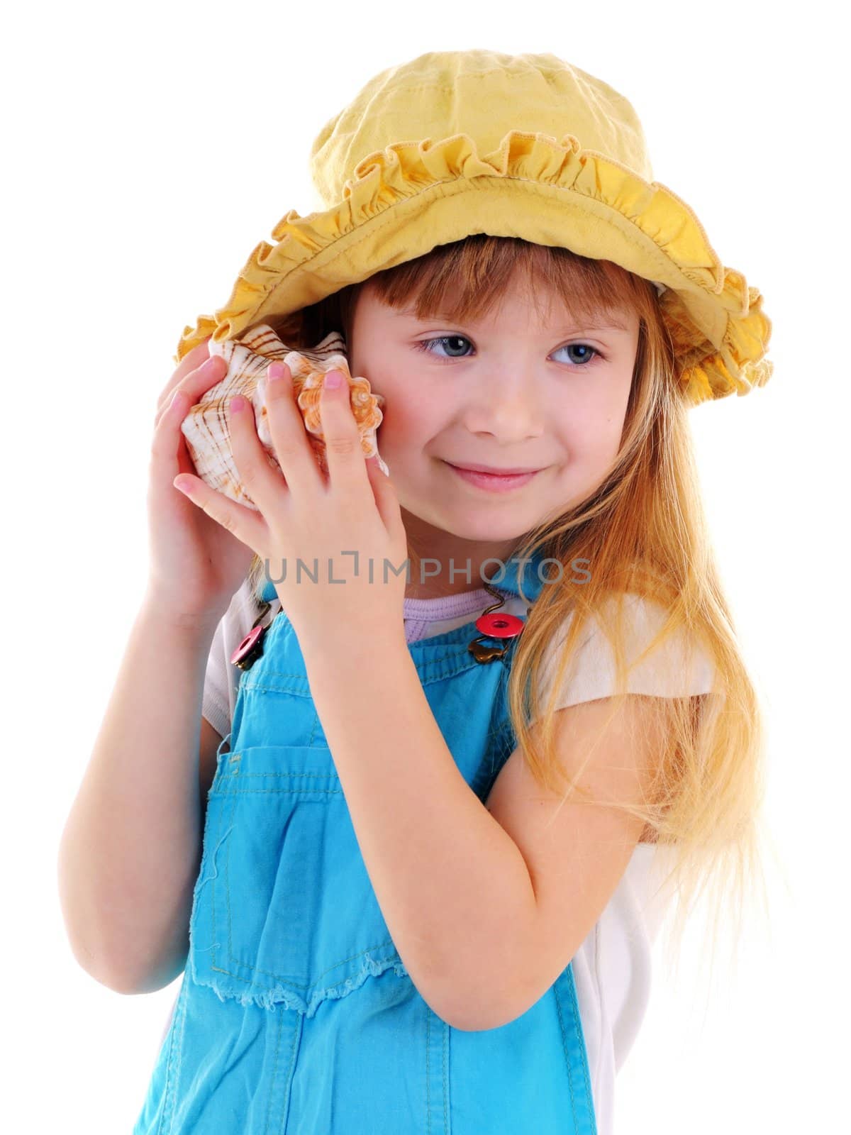 Nice blonde girl is listenind a sea shell on white background