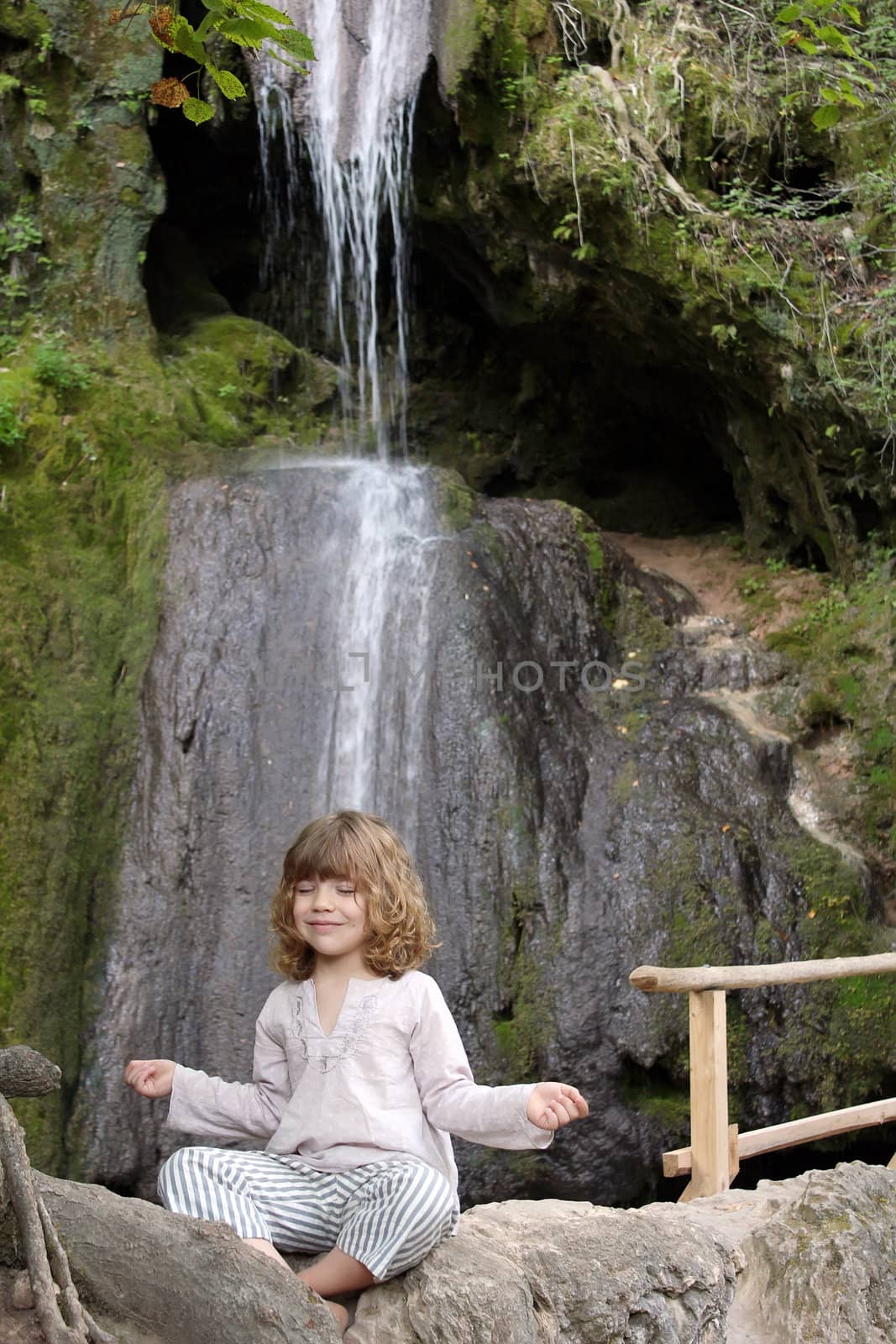 little girl meditates in nature by goce