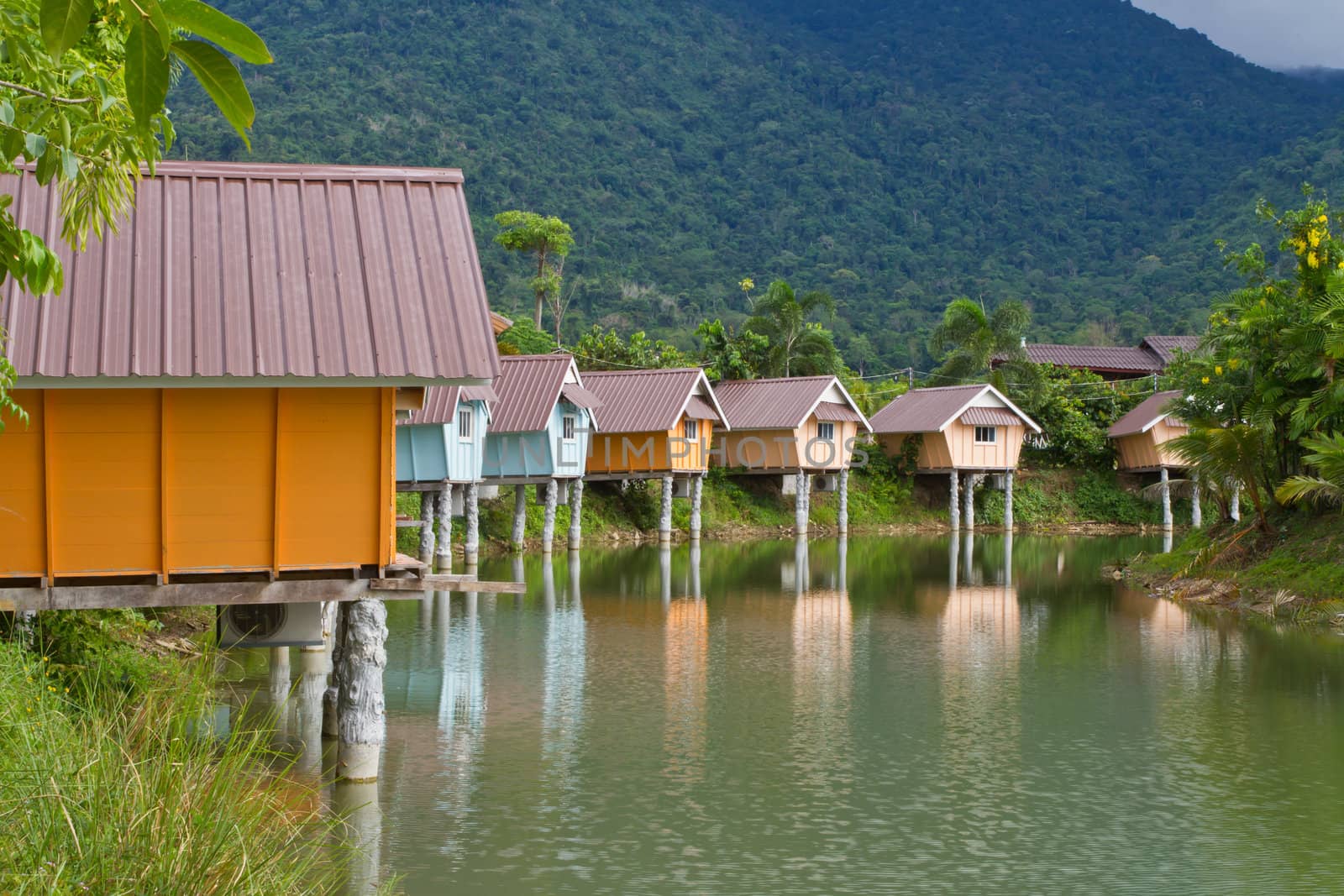 colorful resort and lake in front of the mountain