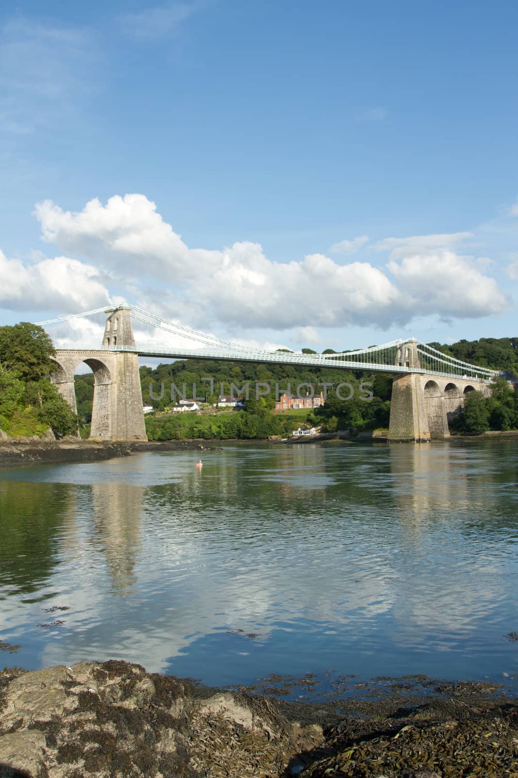 A view of the historic Menai suspension bridge spanning the Menai Straits, Gwynnedd, Wales, UK.