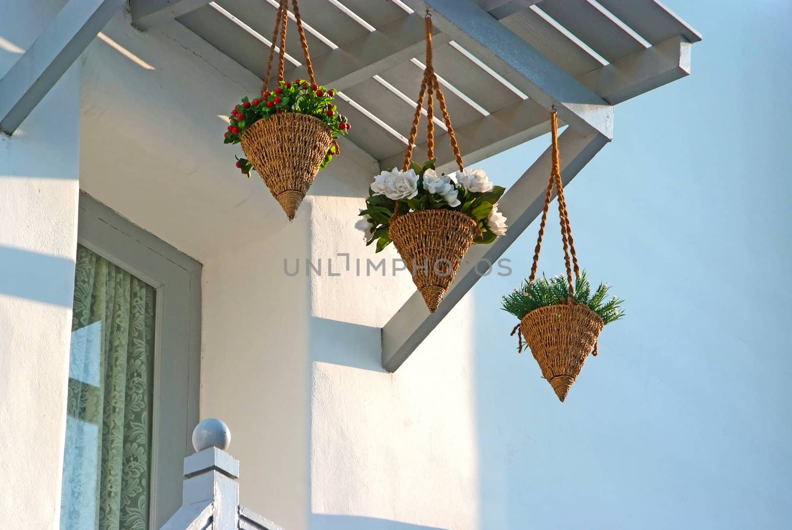 Decorative basket of flowers at the edge of the window.