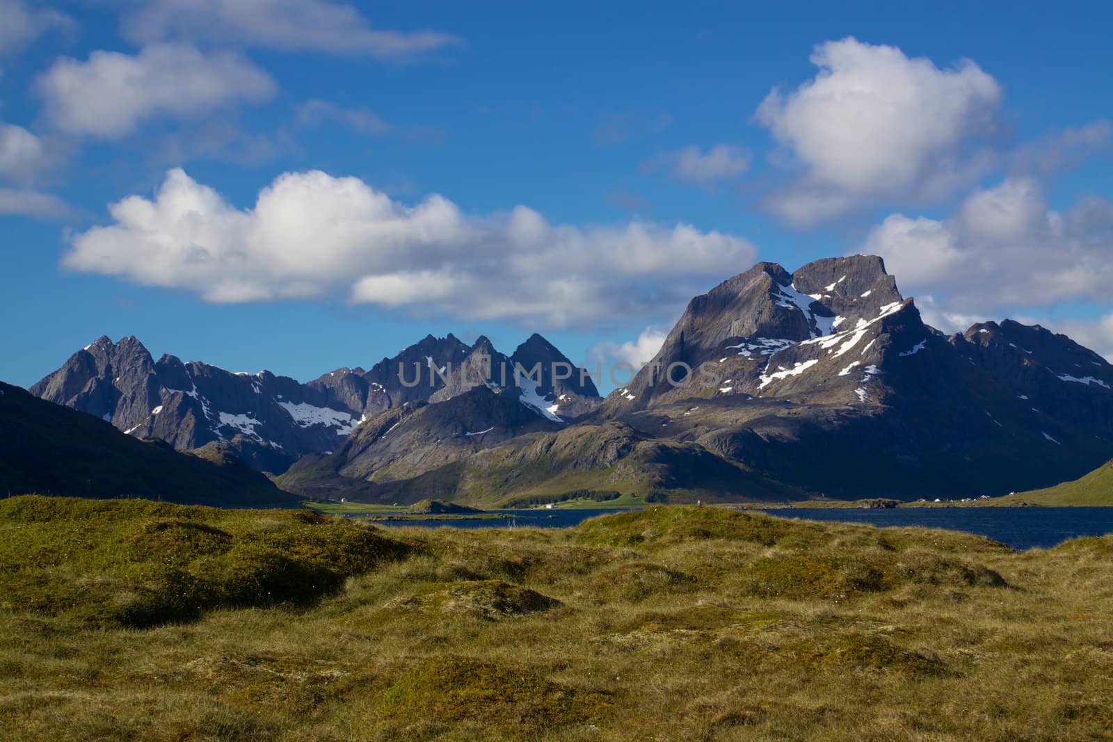 Dramatic mountain peaks of Lofoten islands in Norway with fjords and small fishing villages along the coast