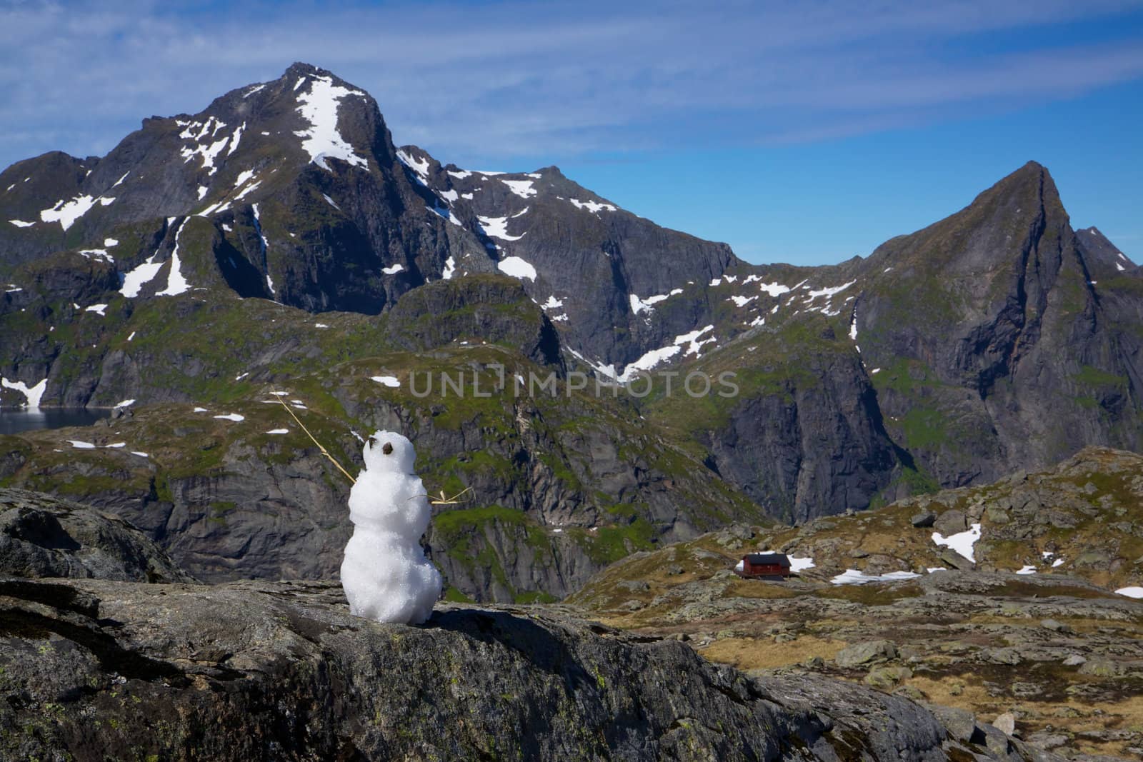 Snowman in far north on Lofoten Islands in Norway during short arctic summer
