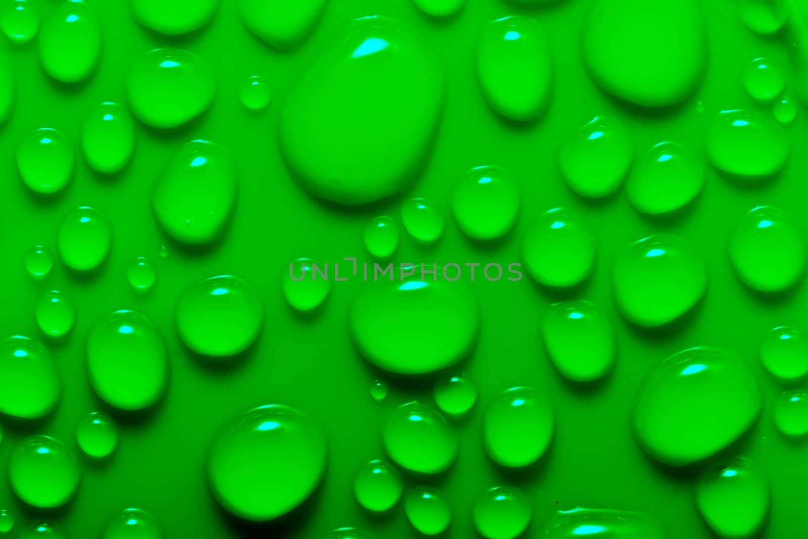Water drops on a green surface