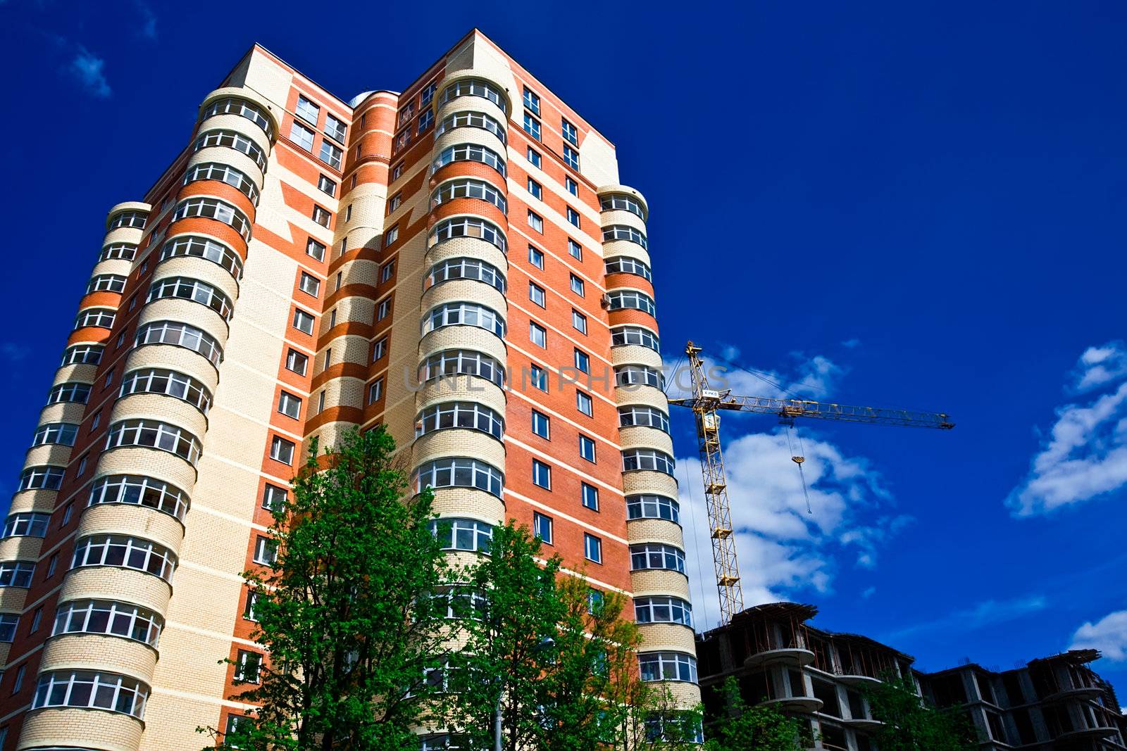 High modern apartment building under blue sky