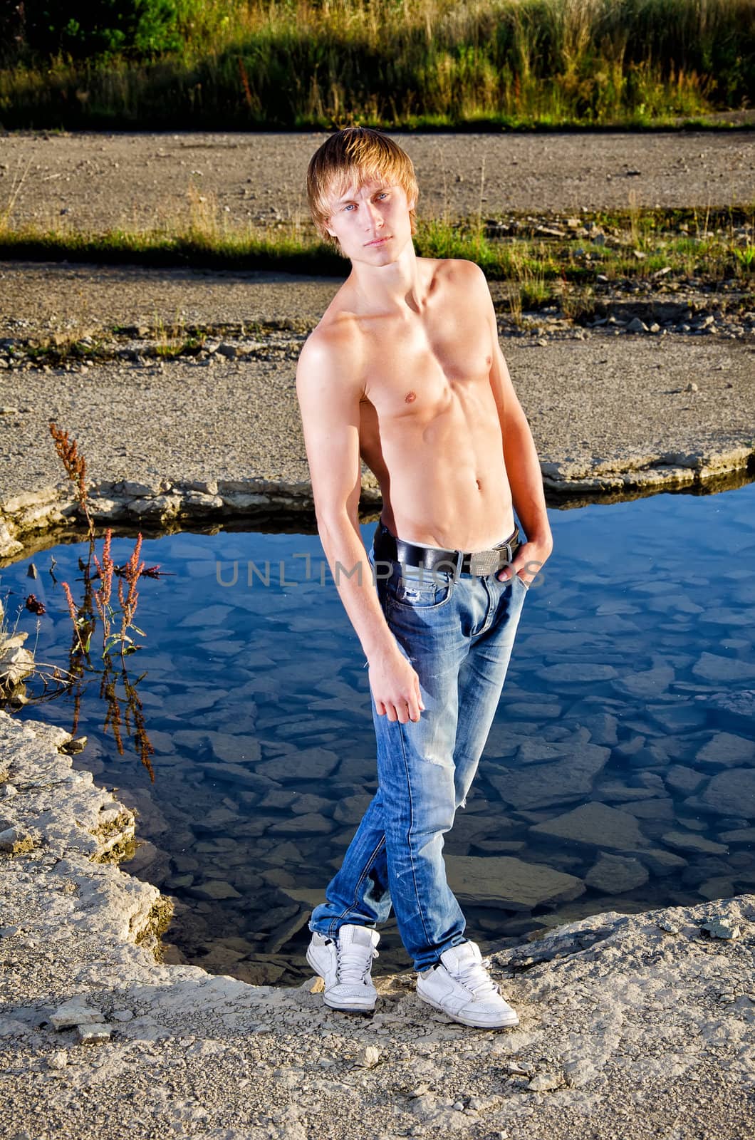 Handsome man posing near water
