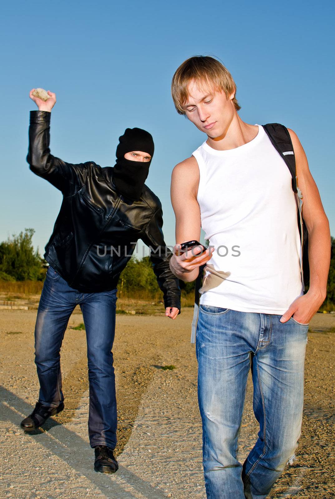 Bandit in mask trying to rob young man