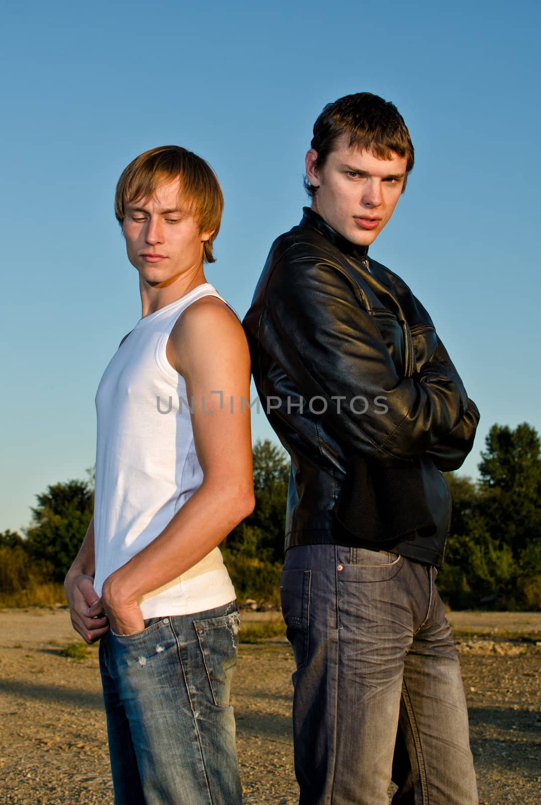 Two men posing outdoors