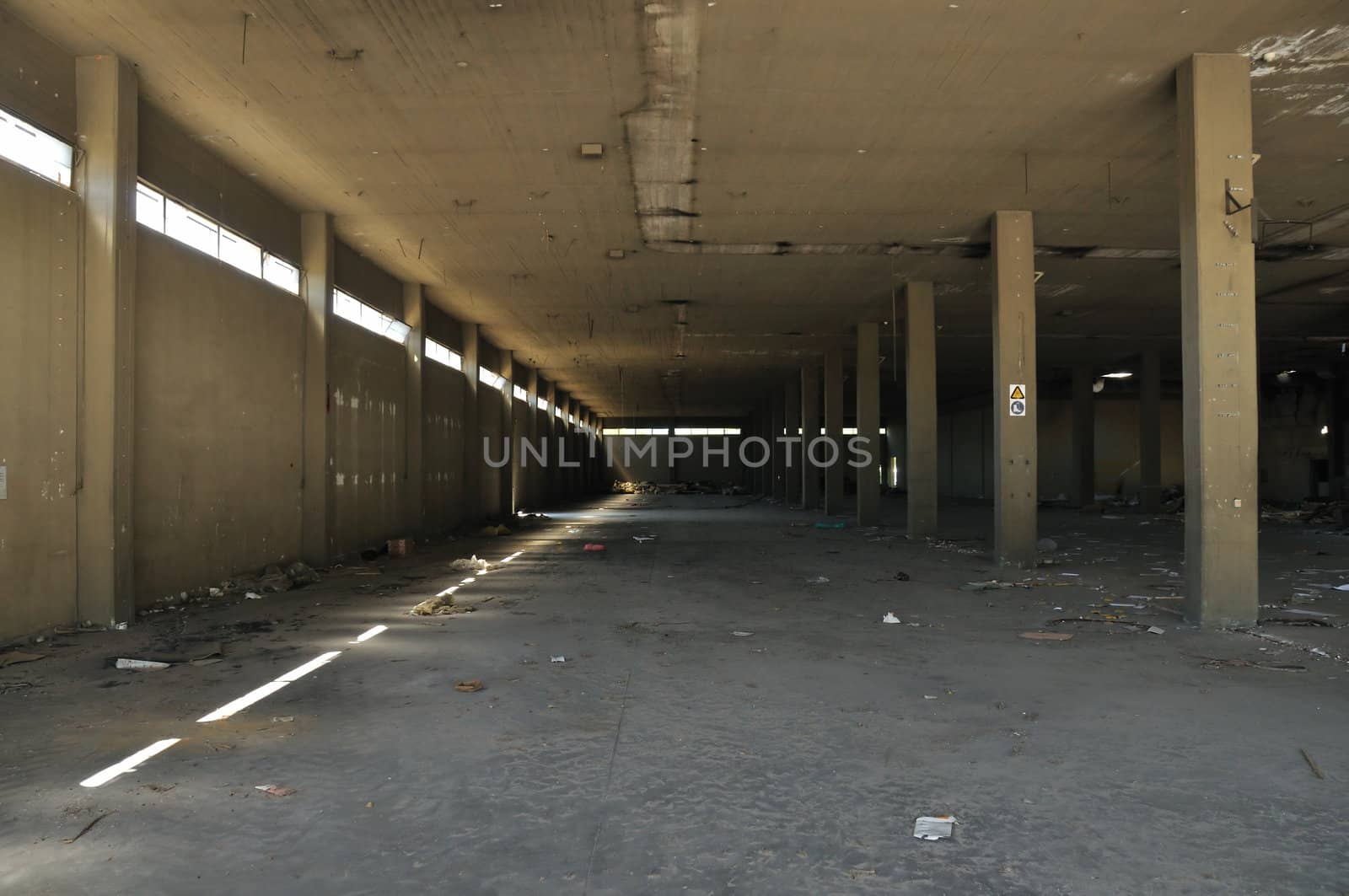 Dirty floor concrete wall and ceiling in abandoned factory. Industrial architecture.
