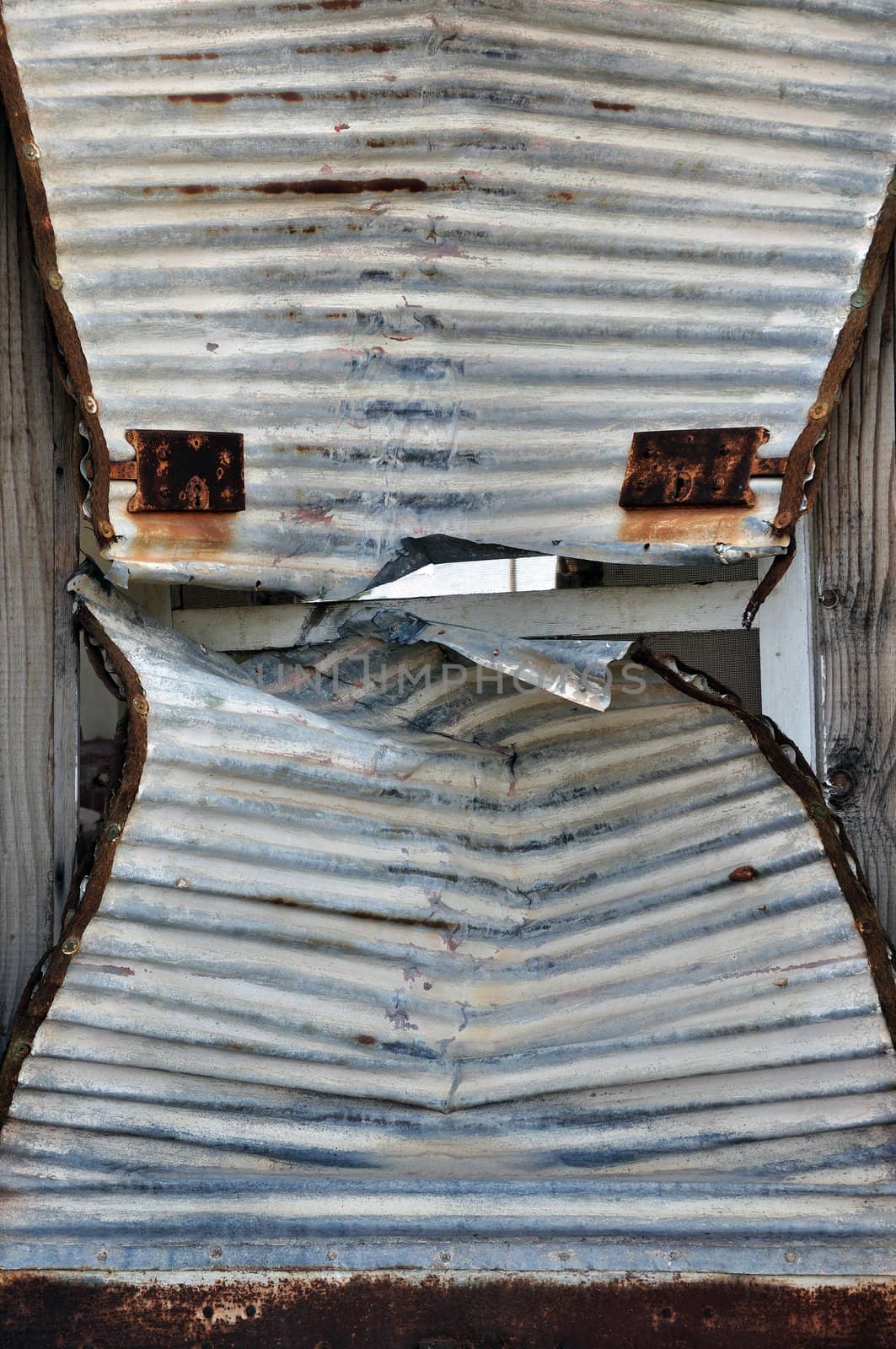 Rusty iron door shutter cracked open. Background metal texture.