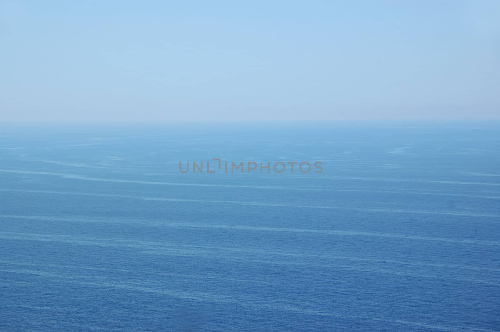 Ocean currents deep sea water and sky horizon. Nature background.