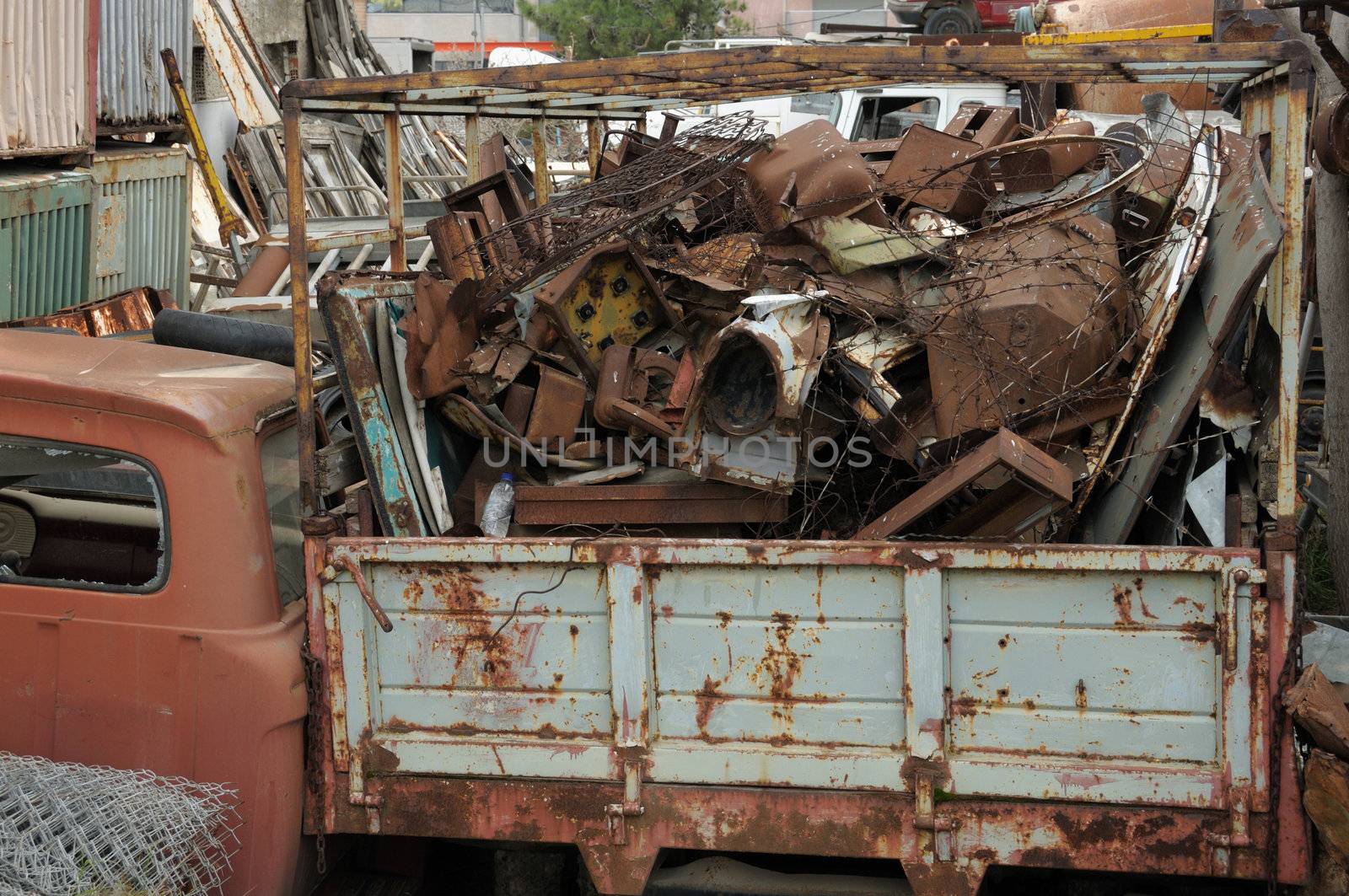 Pile of rusty scrap metal at a junkyard.