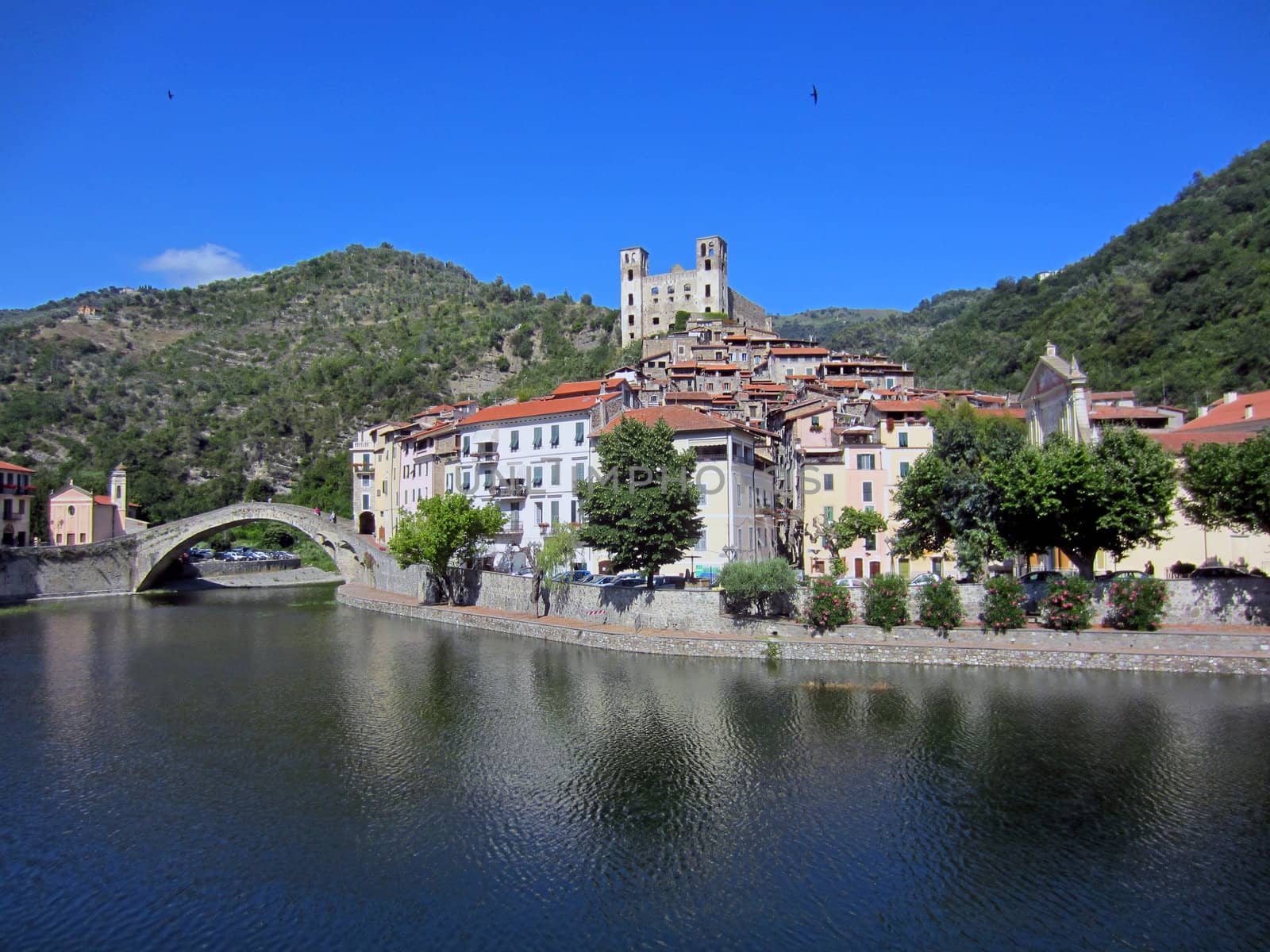 Village with castle and roman stone bridge