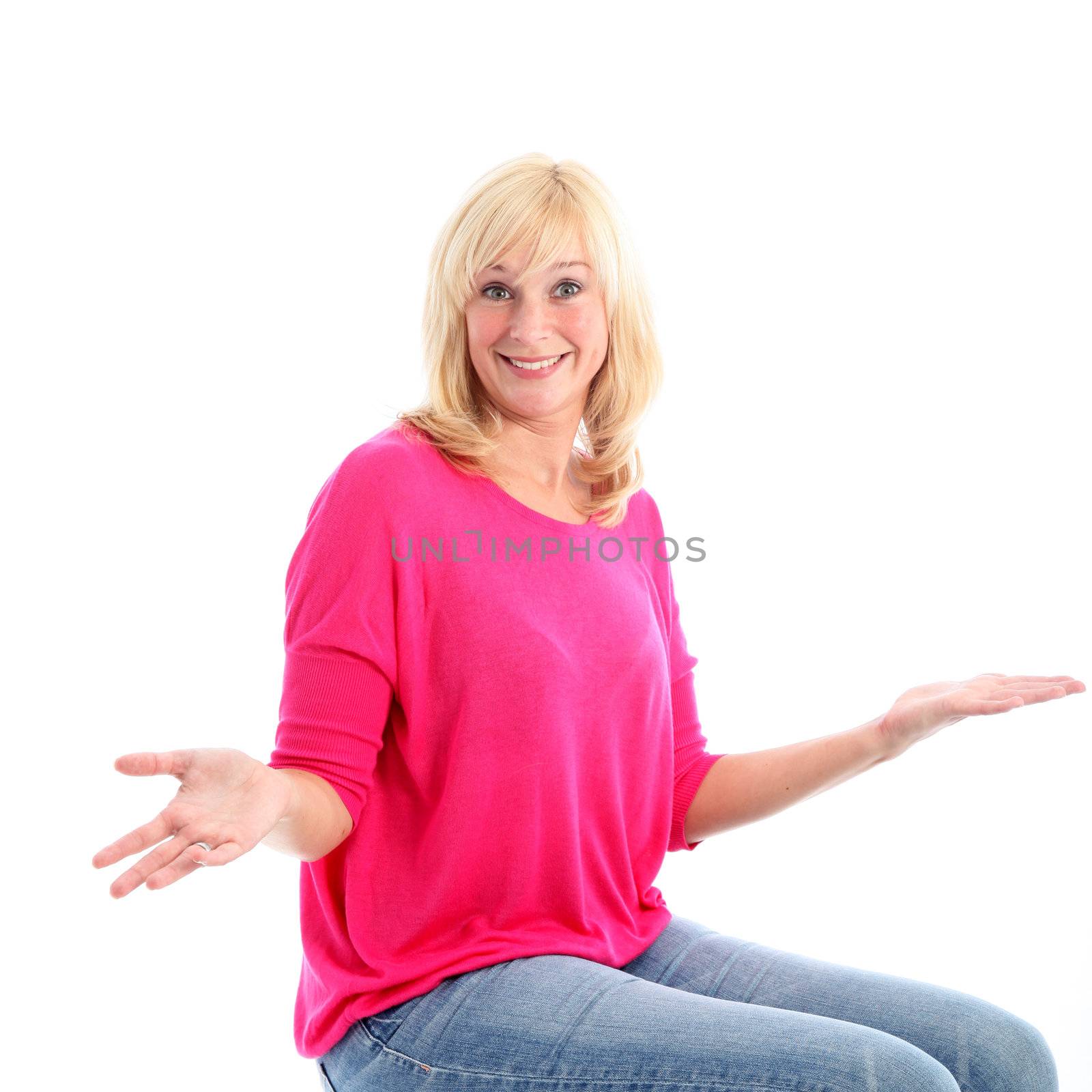 Attractive blonde unconcerned woman shrugging her shoulders with her hands extended palm upwards isolated on white 