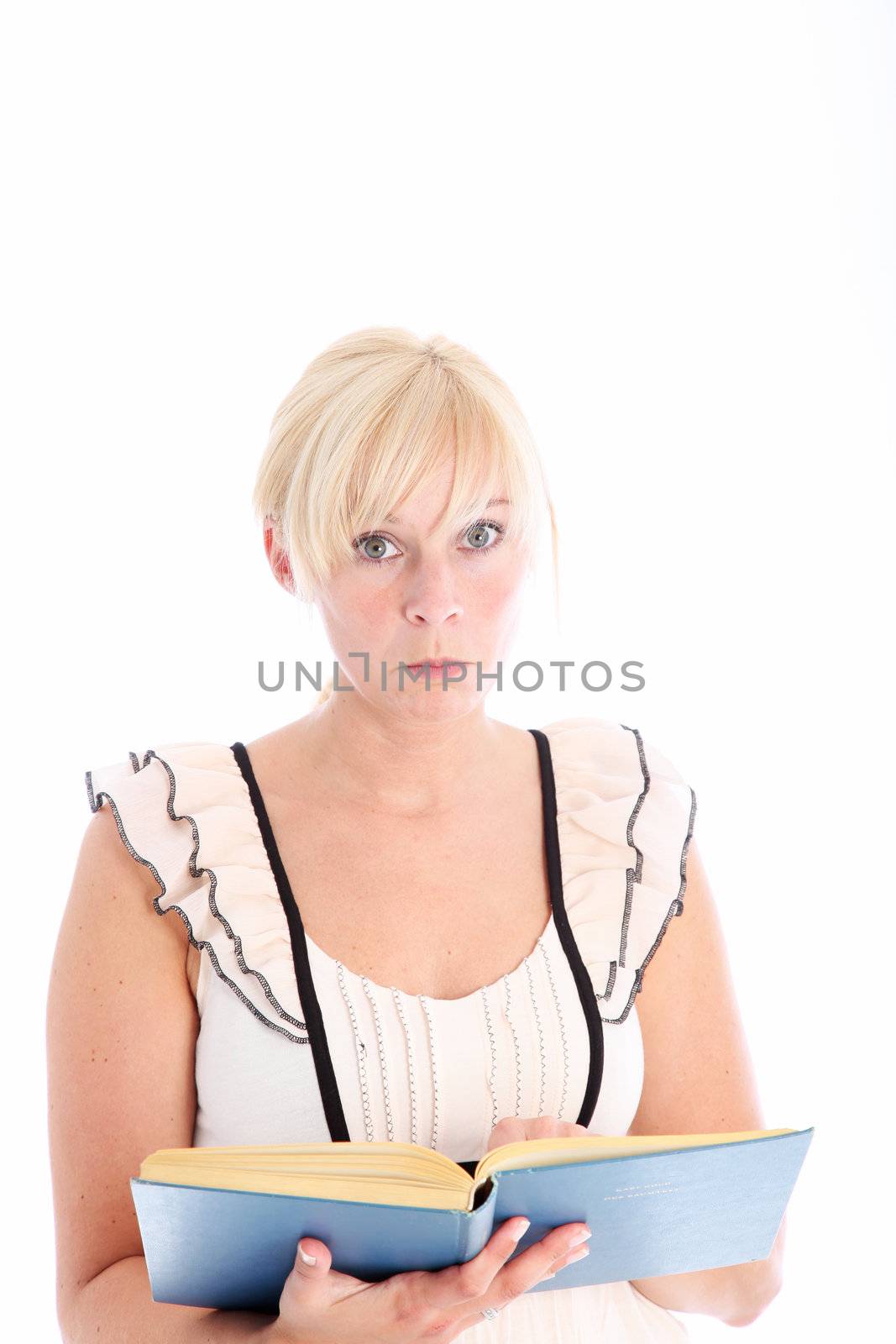 Pretty young blonde woman reading a book she is holding in her hands isolated on white 
