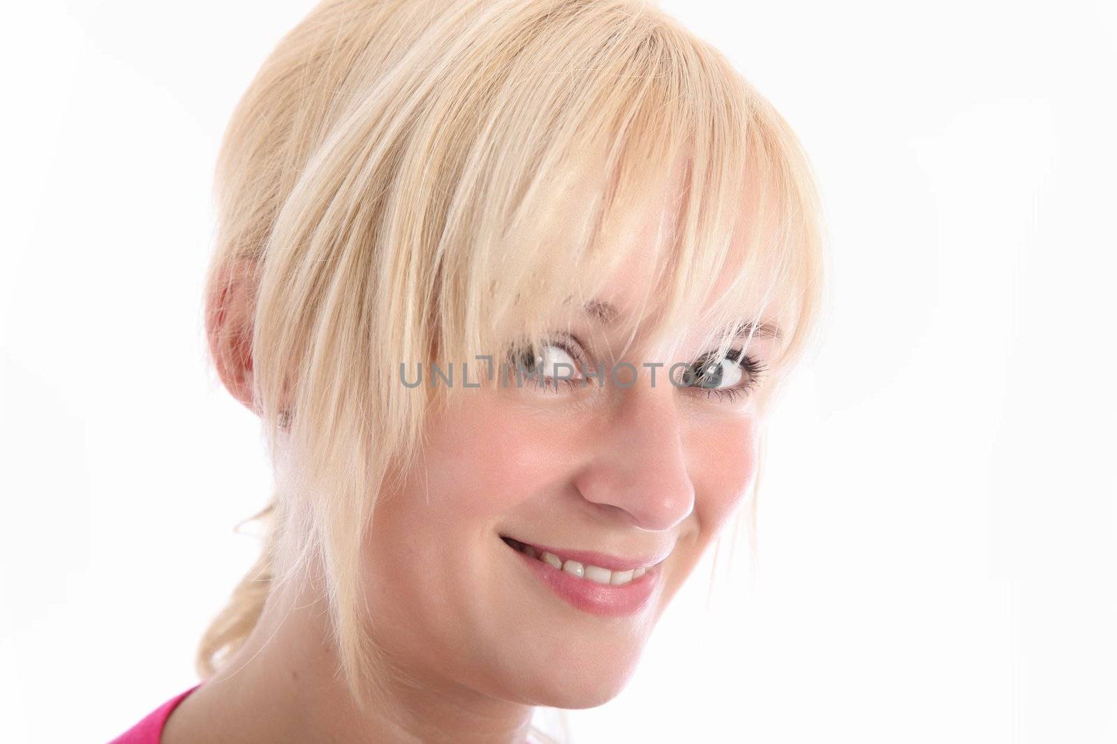Close up portrait of smiling blonde woman with blue eyes on white background