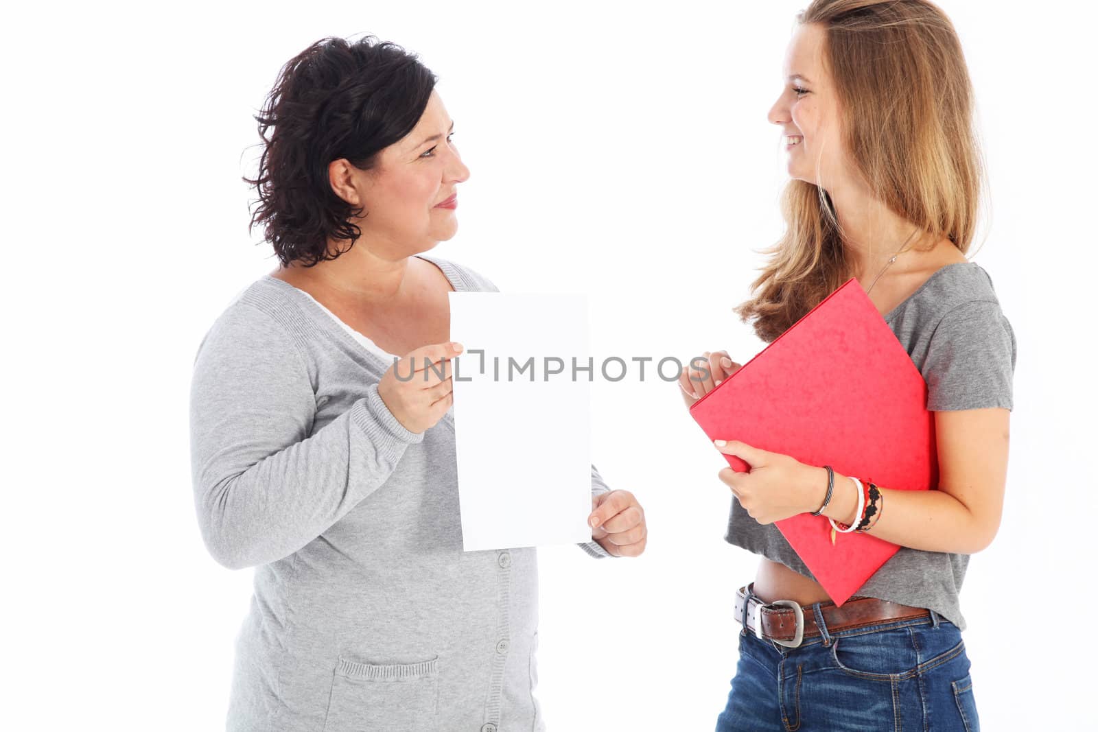 Smiling satisfied teacher presenting a young female student with a blank piece of paper representing her latest project