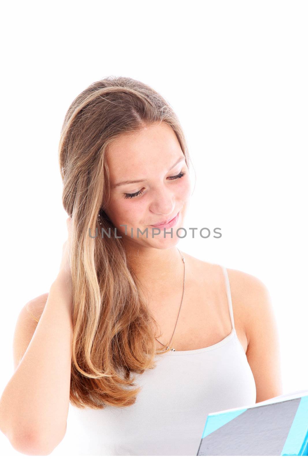 Young girl reading a book with a look of tender amusement as she enjoys the contents isolated on white Young girl reading correspondence with a look of tender amusement as she enjoys the contents isolated on white