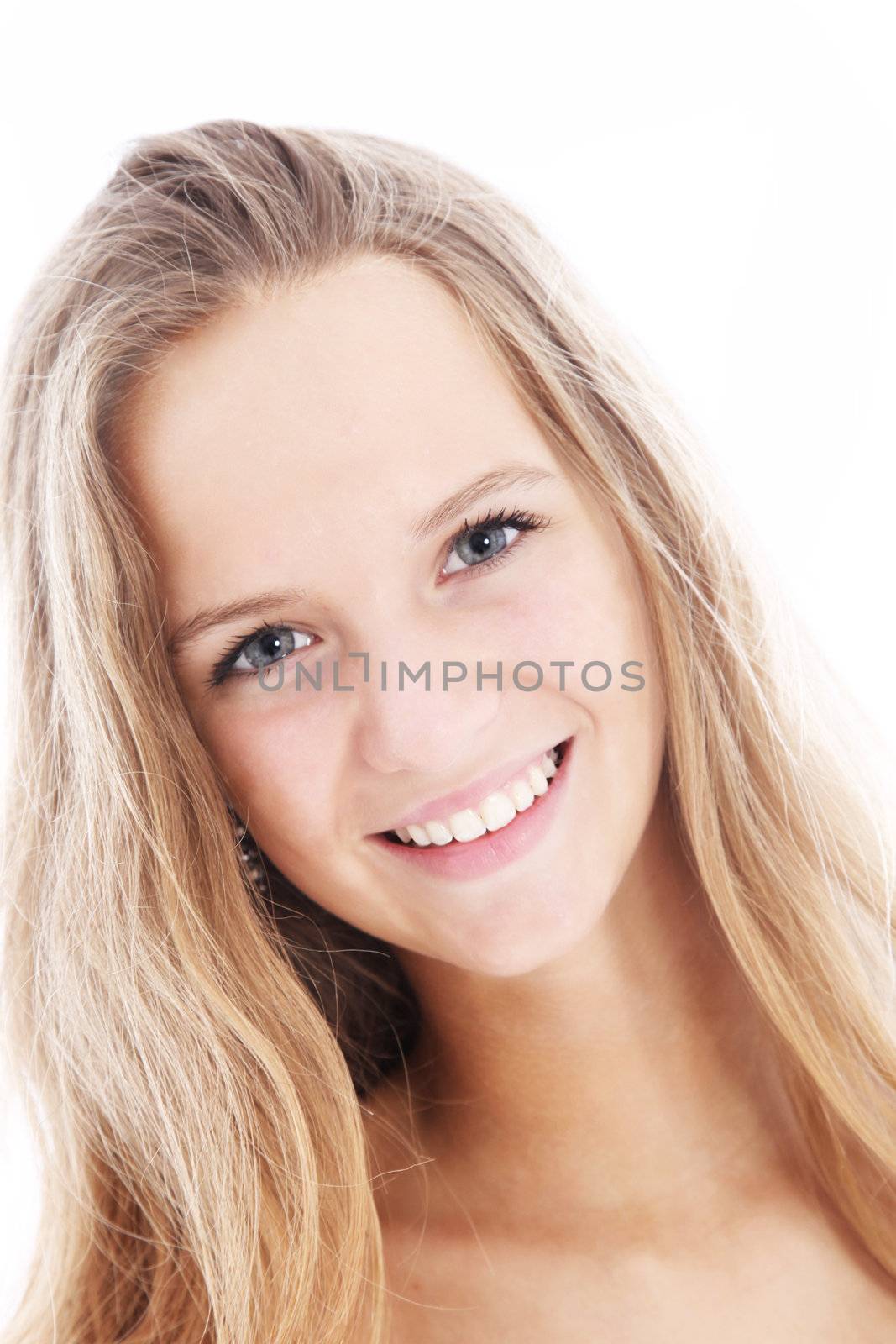 Headshot of a sincere friendly teenage student with long blonde hair and a lovely smile looking directly into the camera 