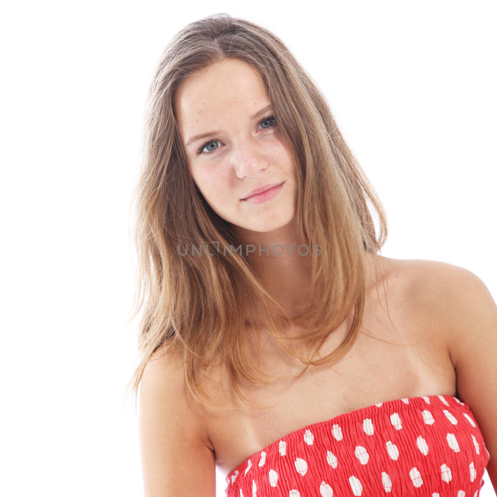 Shy withdrawn teenage girl with a reserved expression standing looking at the camera isolated on white 