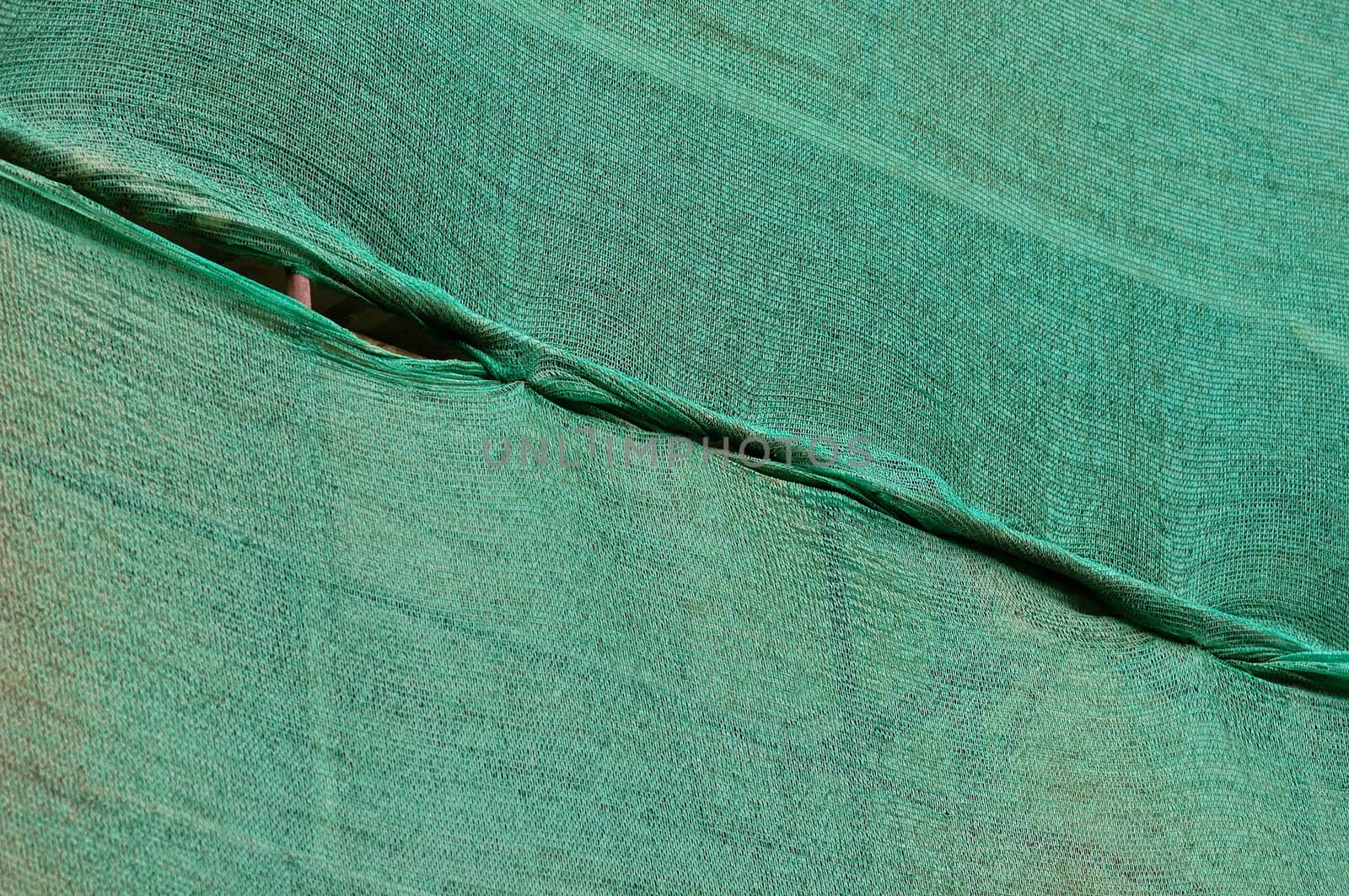 Building under construction green debris netting background.