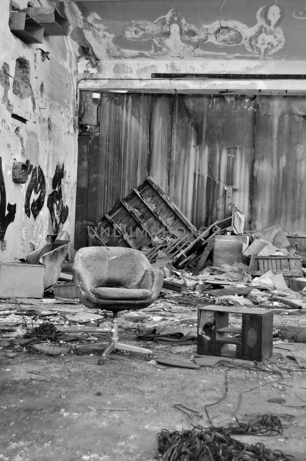 Dusty chair in abandoned vinyl records pressing factory. Black and white.