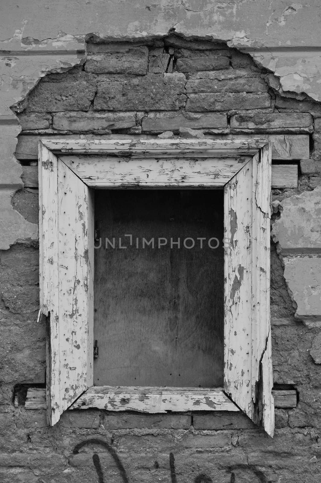 Empty window frame broken brick wall grunge background. Black and white.