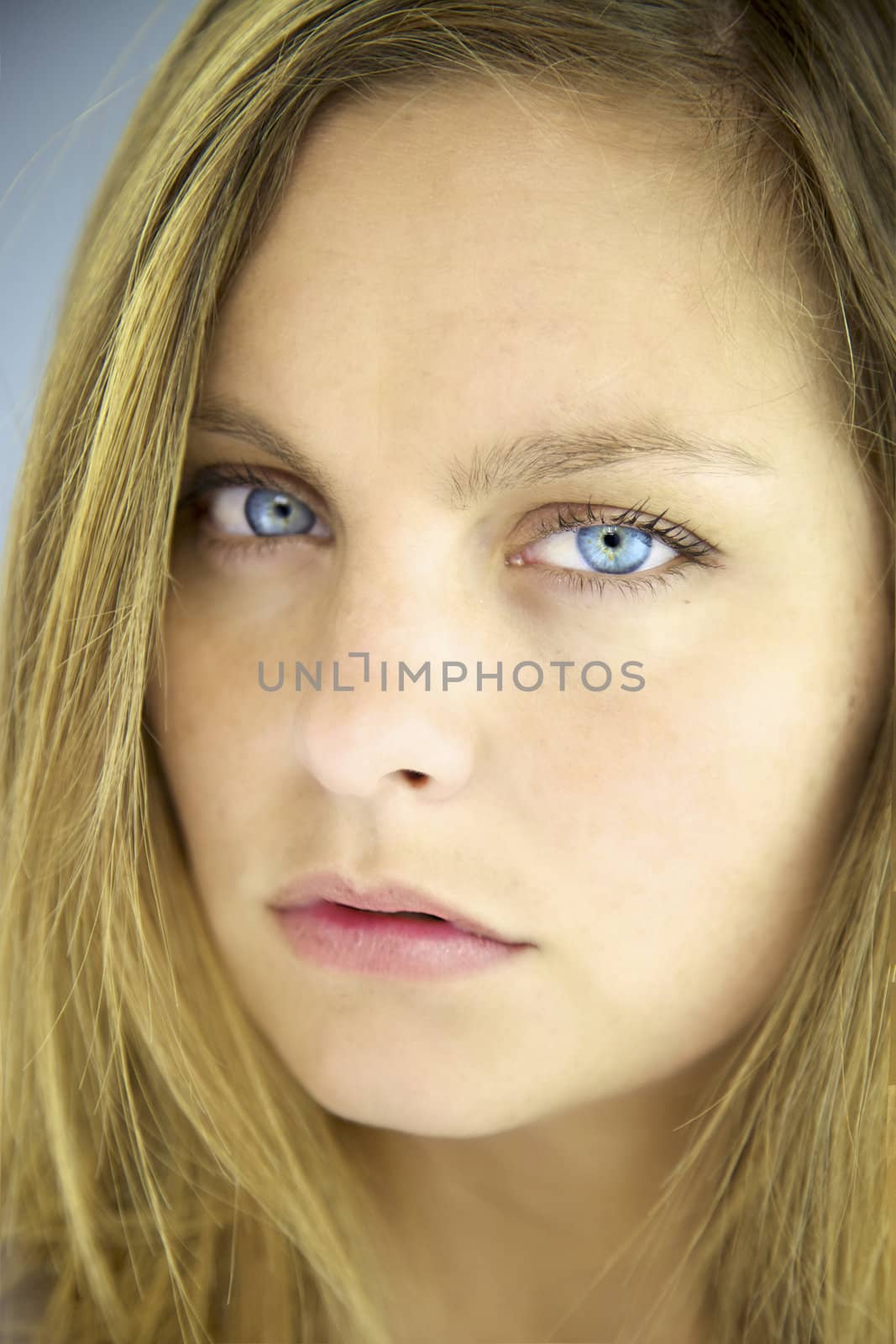 Closeup of serious blonde girl by fmarsicano