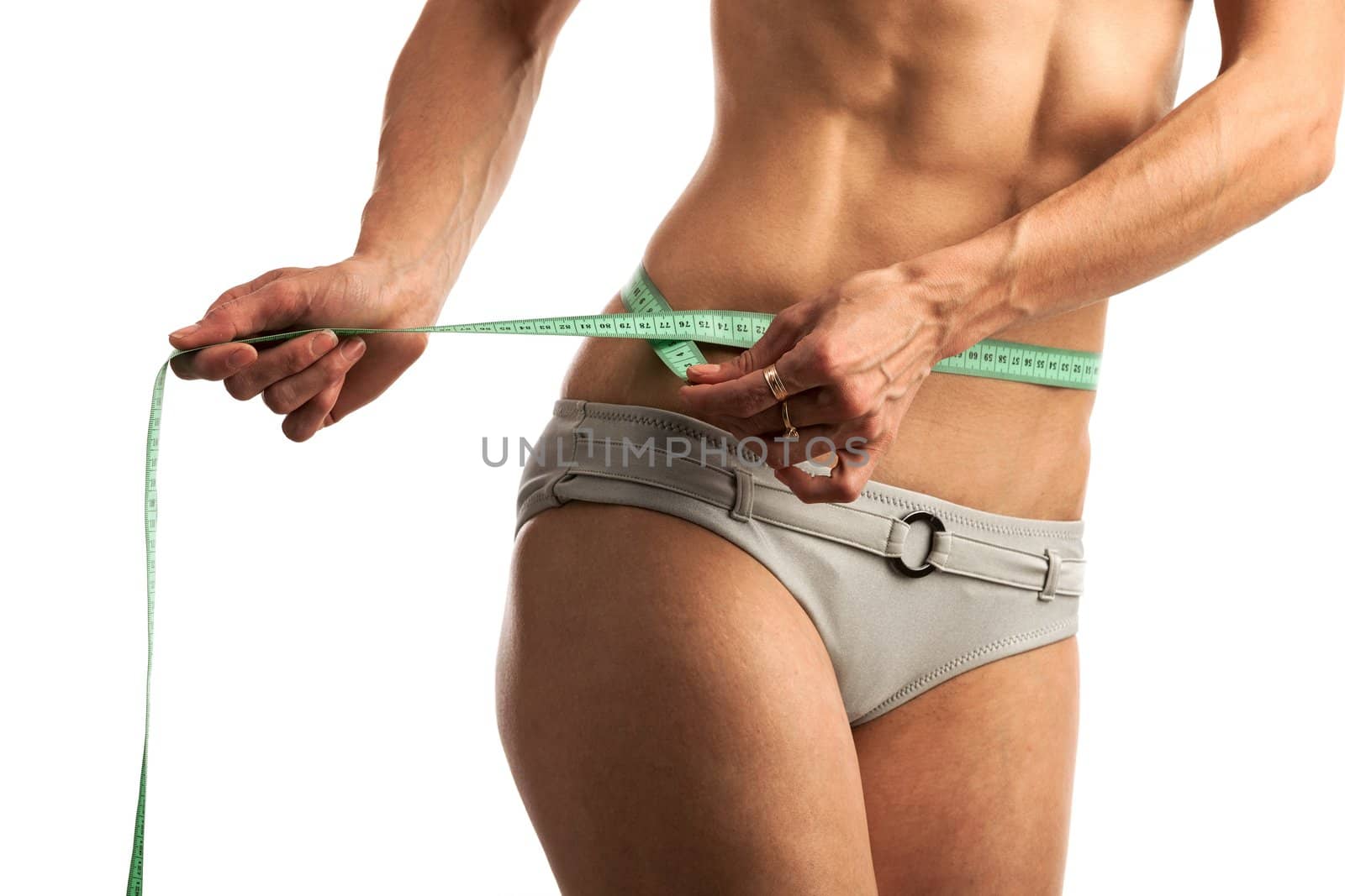 Cropped view of young fitness woman with measuring tape over white background