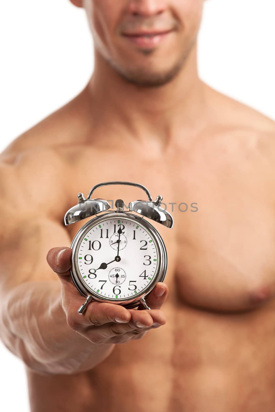 Cropped view of a muscular young man holding clock by photobac