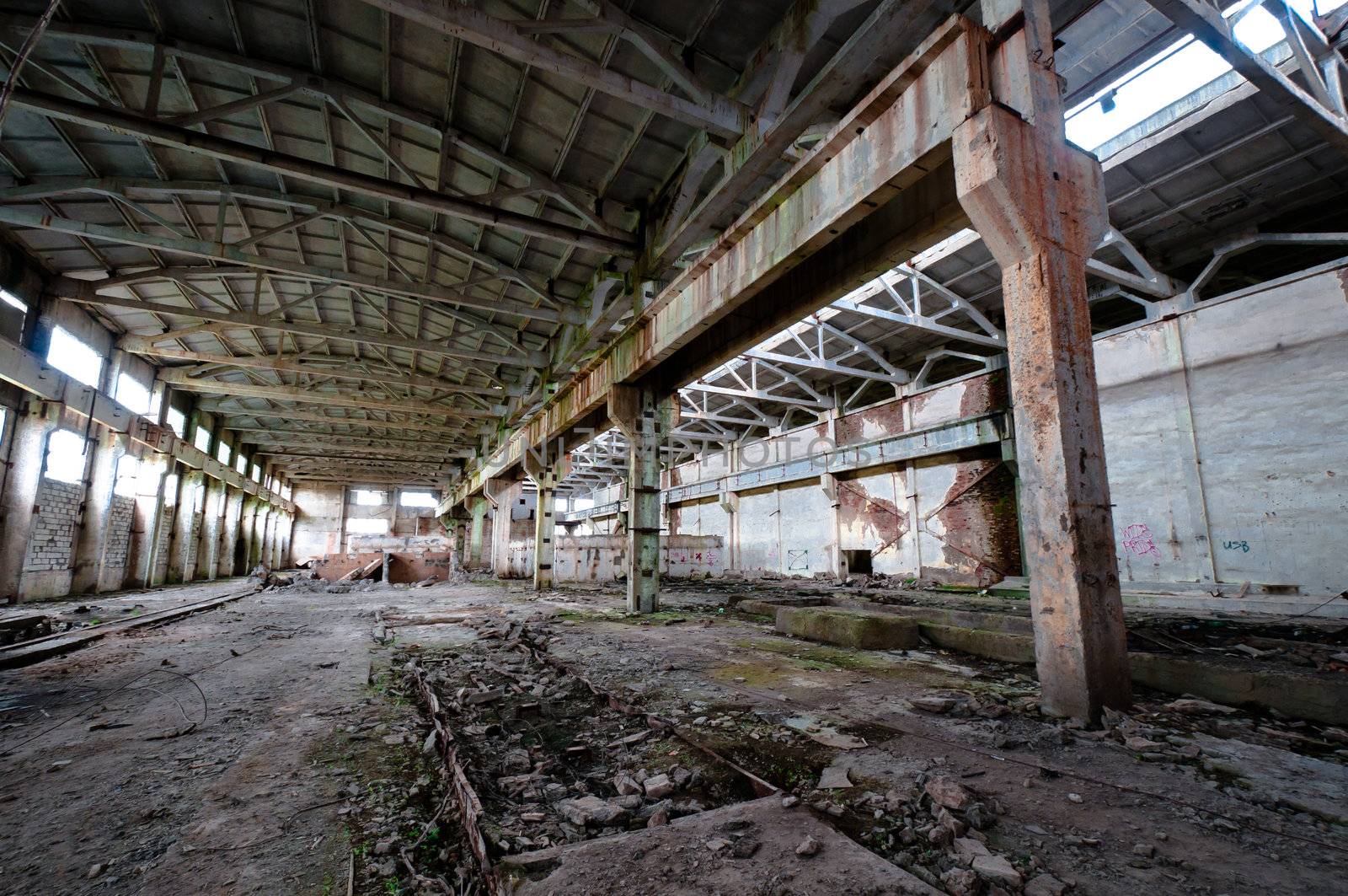 Old and deserted plant interior with weathered walls and overlap