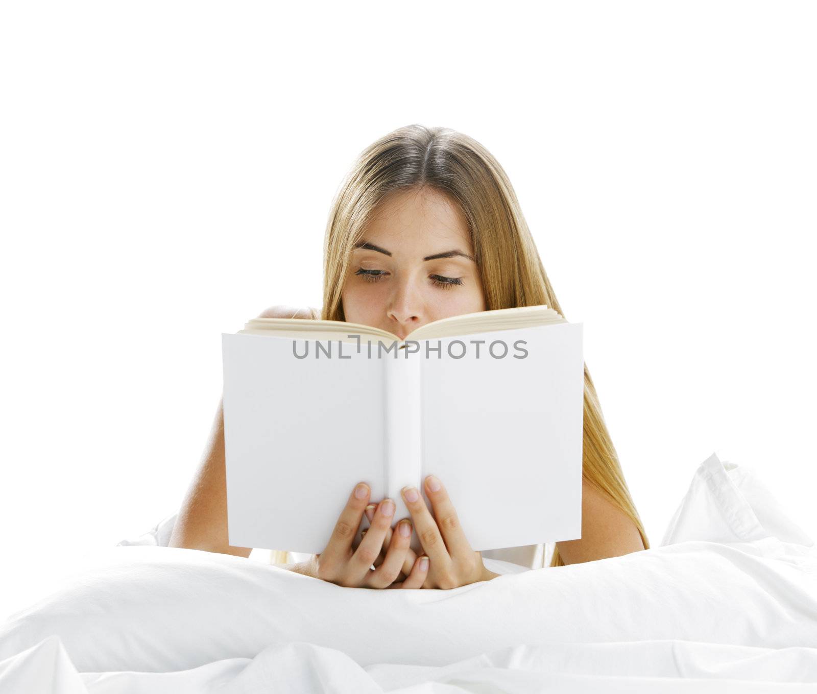 Young beautiful woman reading in bed, cover book is blank