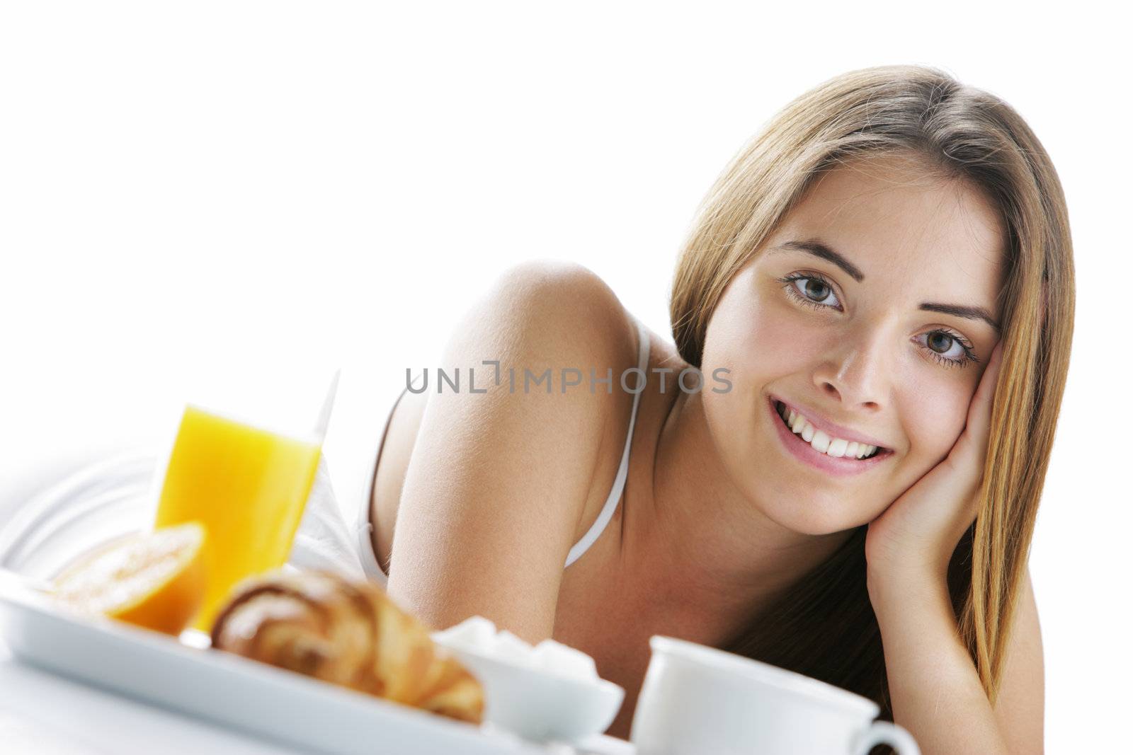Young beautiful woman having breakfast in bed.