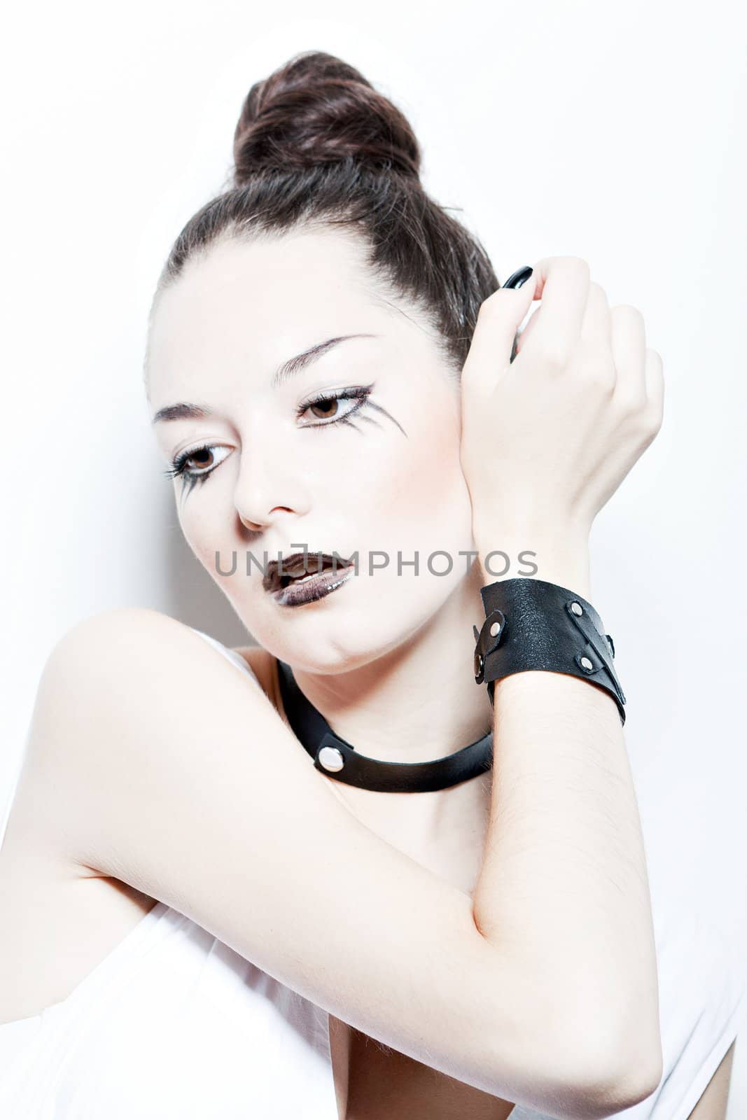 fashion portrait of a girl with dark make-up on a white background..