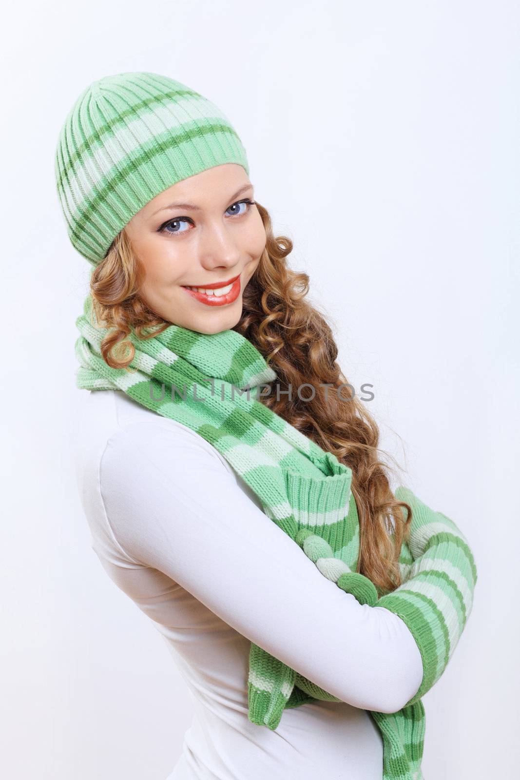 Young woman wearing winter hat and warm scarf by sergey_nivens