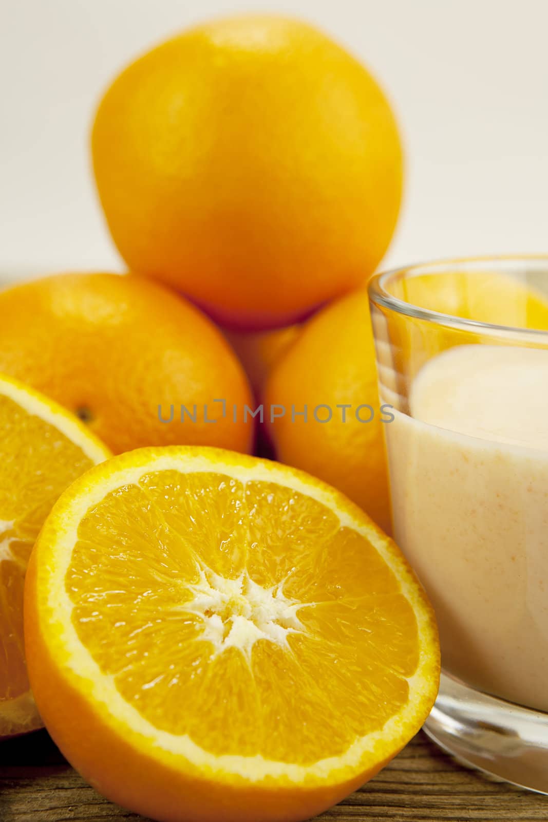 fresh tropical orange yoghurt shake dessert on wooden background