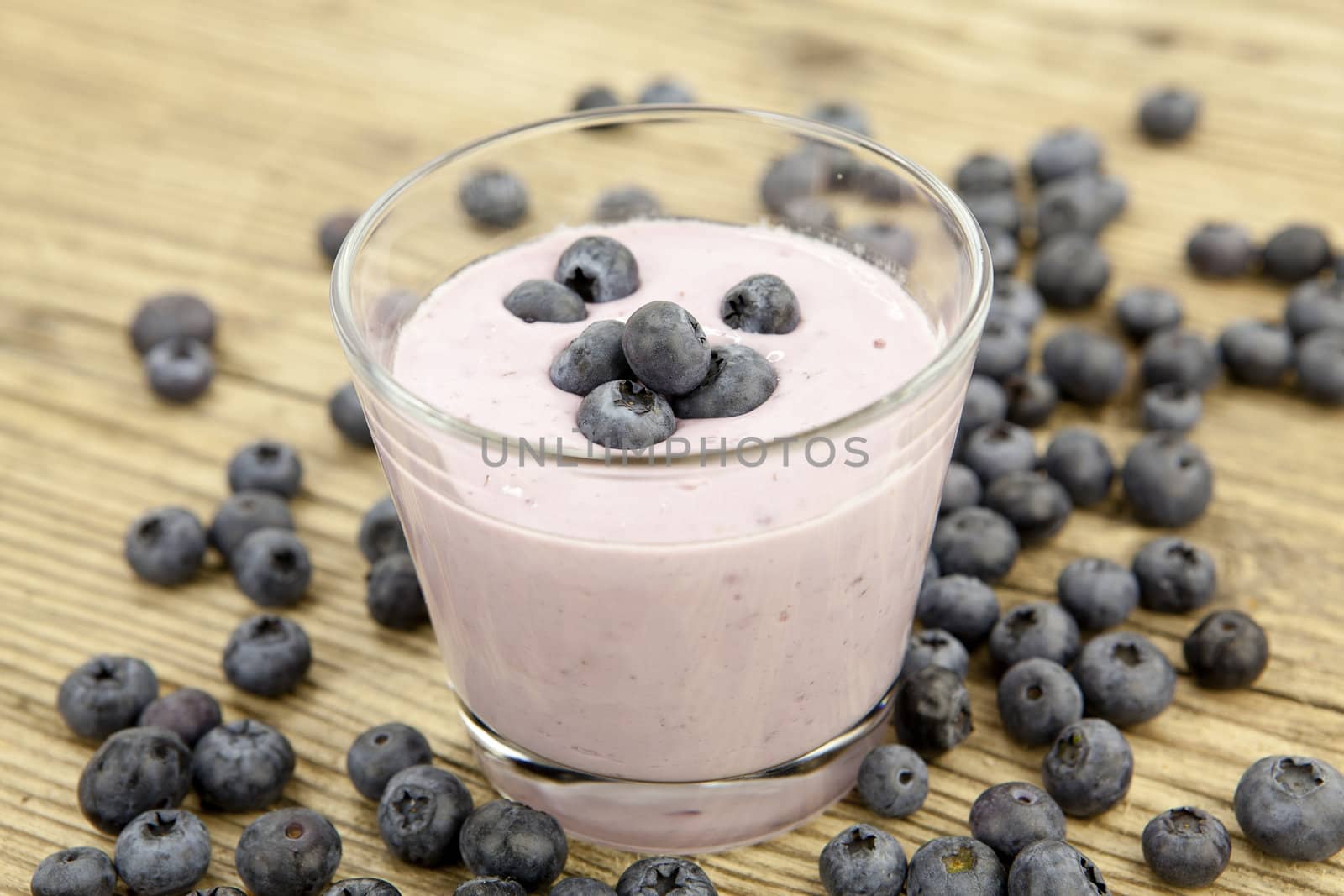 fresh delicious blueberry yoghurt shake dessert on wooden background