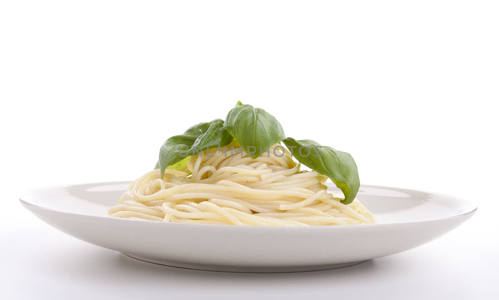 fresh delicious pasta with basil isolated on white background