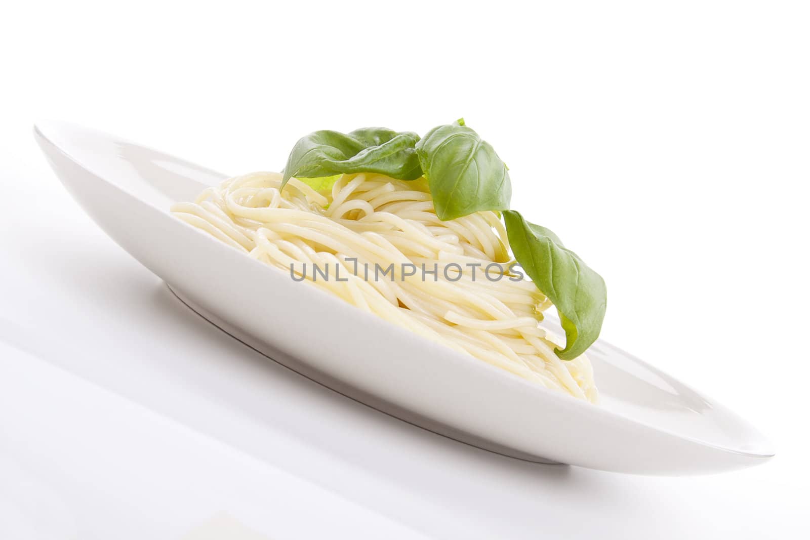 fresh delicious pasta with basil isolated on white background