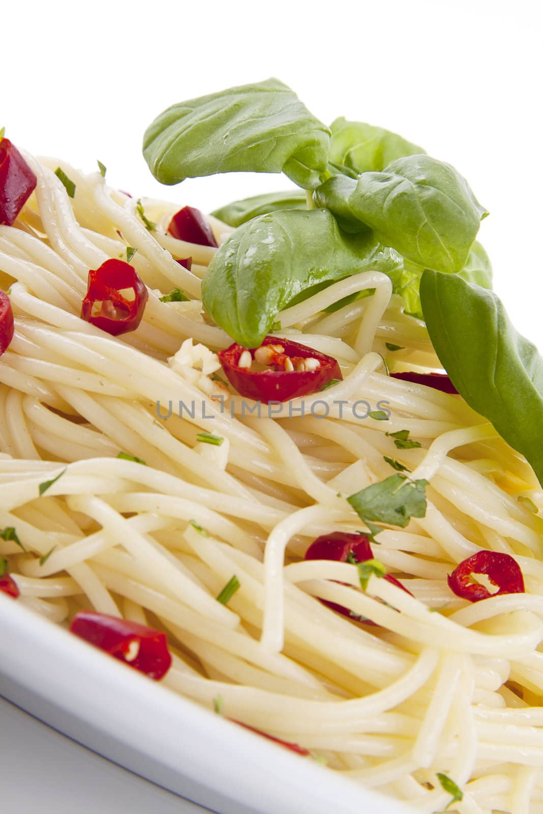 fresh pasta with chilli and basil with salad isolated on white background
