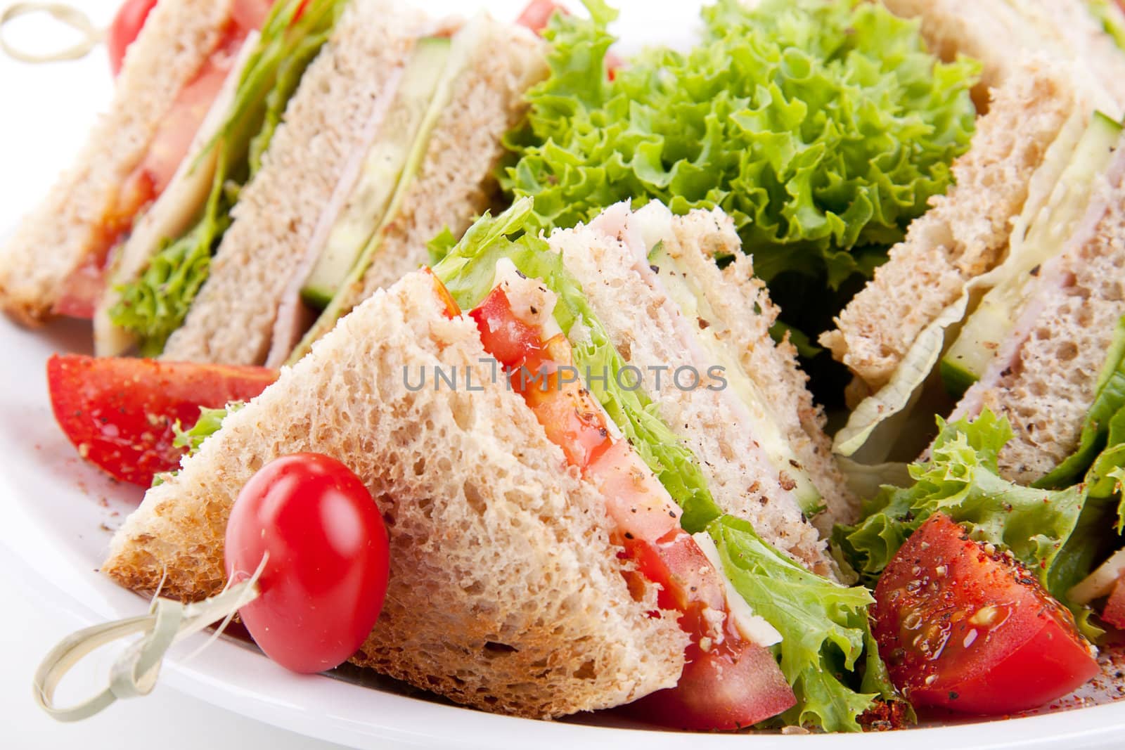 fresh tasty club sandwich with lettuce cheese ham and toast isolated on white background