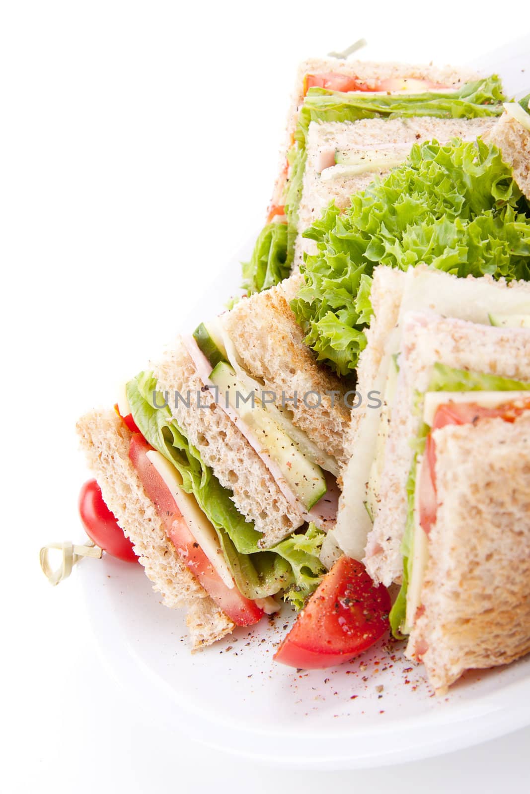 fresh tasty club sandwich with lettuce cheese ham and toast isolated on white background