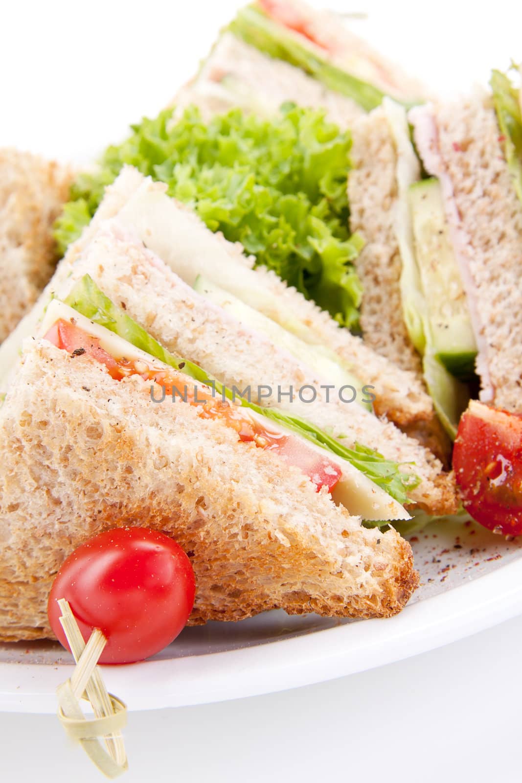 fresh tasty club sandwich with lettuce cheese ham and toast isolated on white background