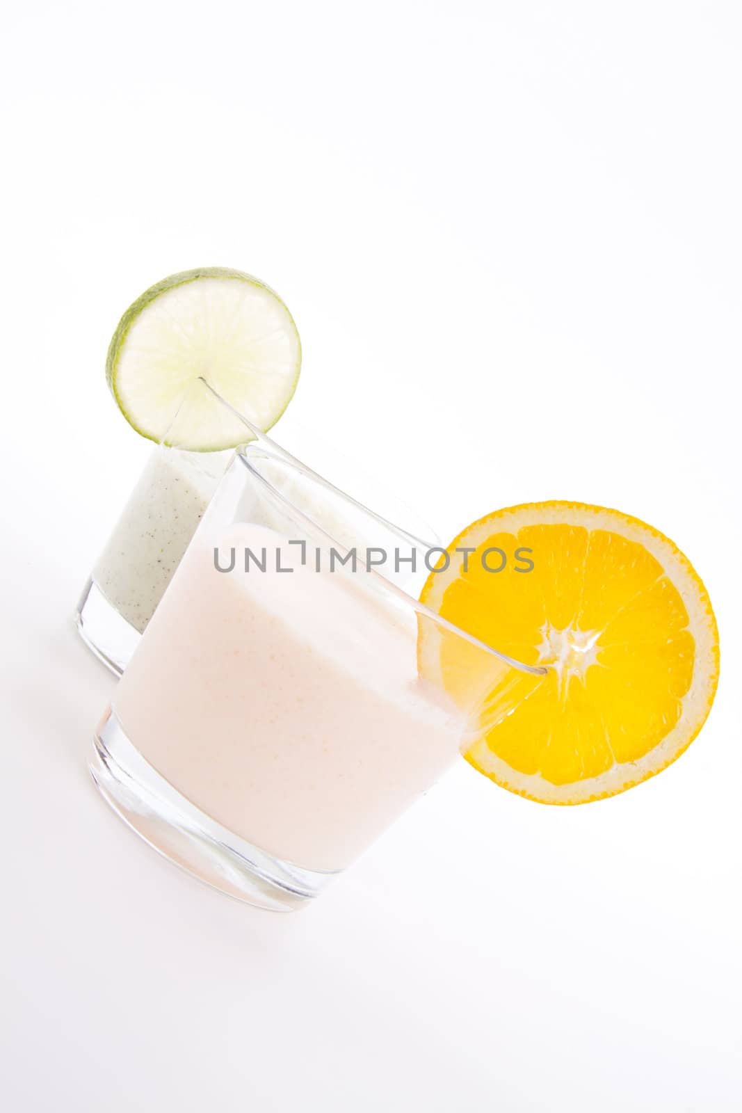 fresh tasty lime and orange yoghurt shake cream isolated on white background