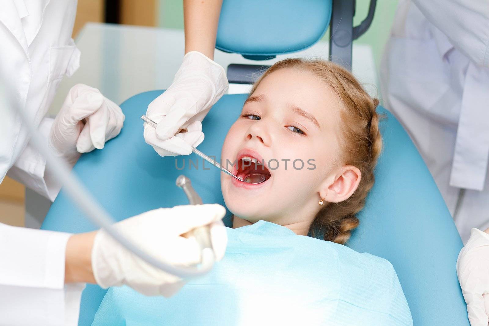 Little girl sitting in the dentists office