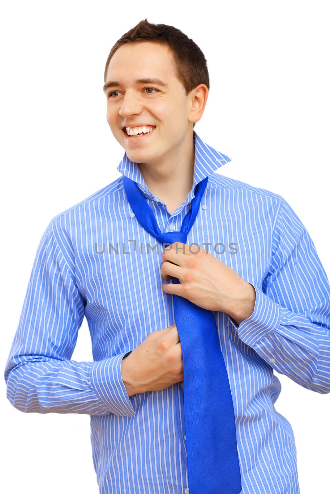 Young business man binding his blue tie by sergey_nivens