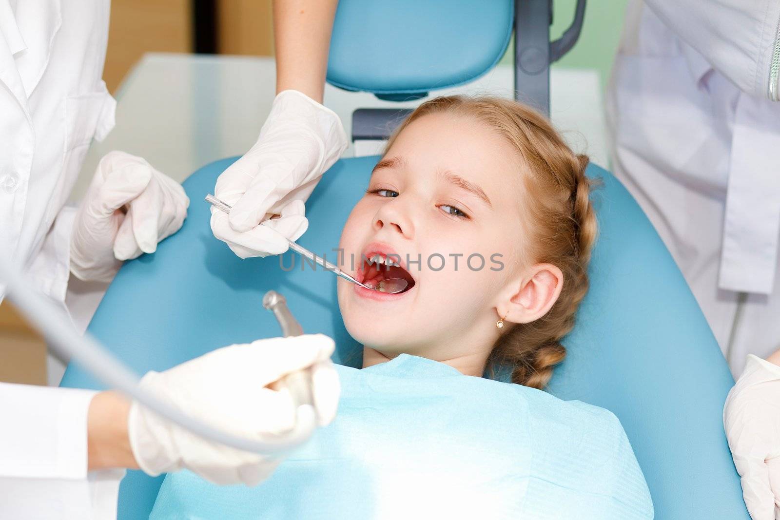 Little girl sitting in the dentists office