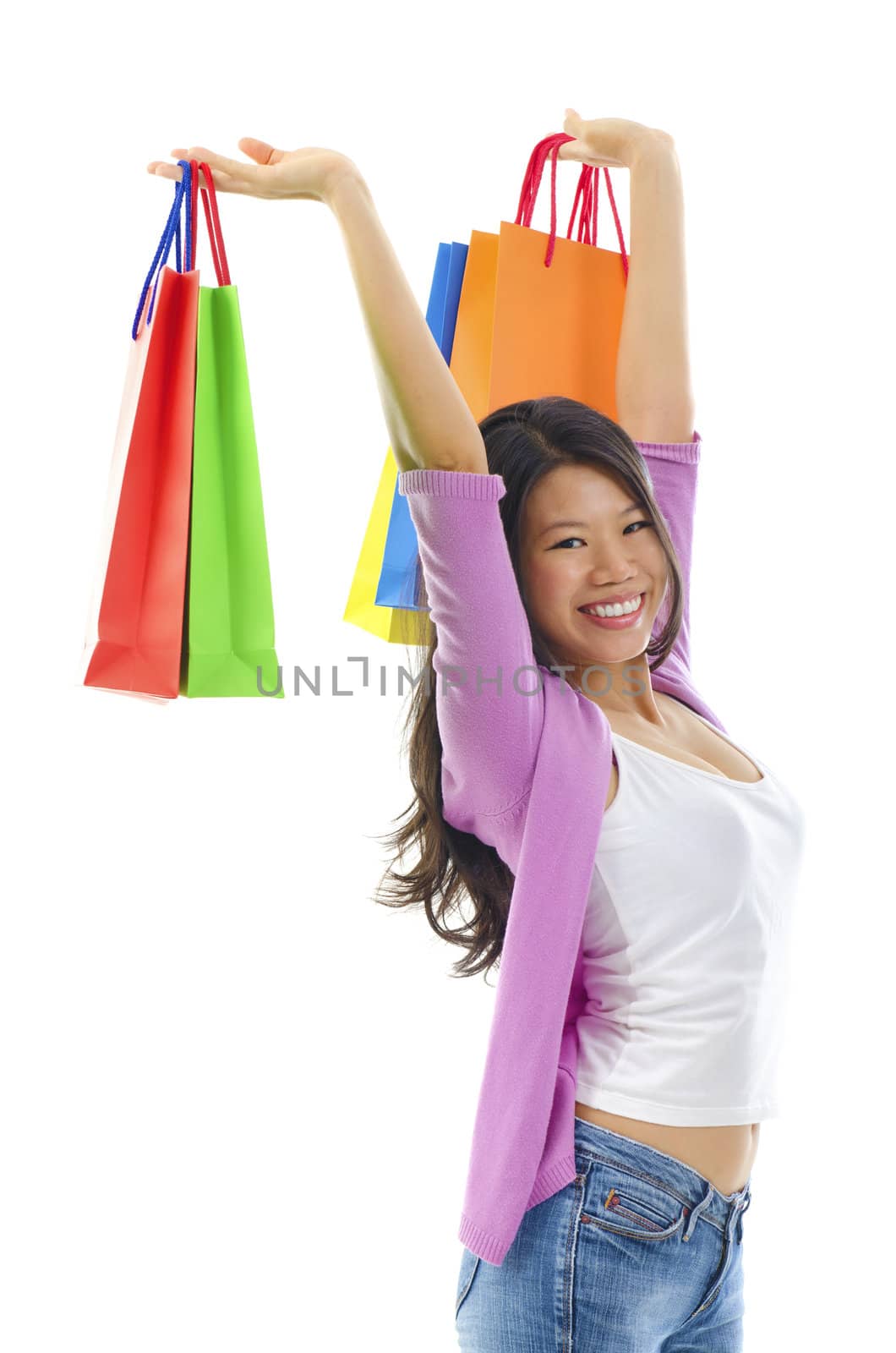 Happy shopper holding shopping bag high over white background