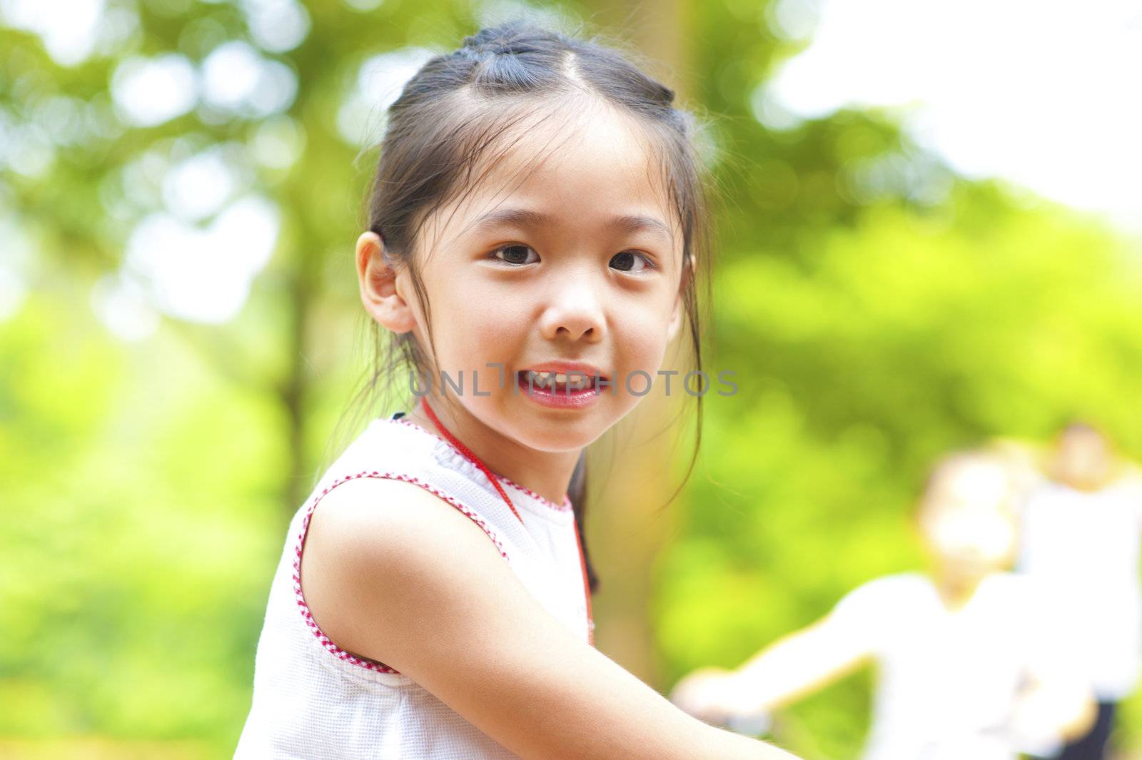 Little Asian girl riding bike outdoor