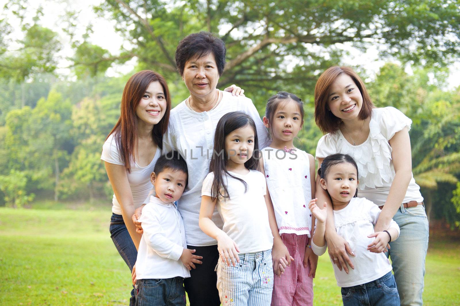 Asian family portrait at outdoor park, 3 generations.